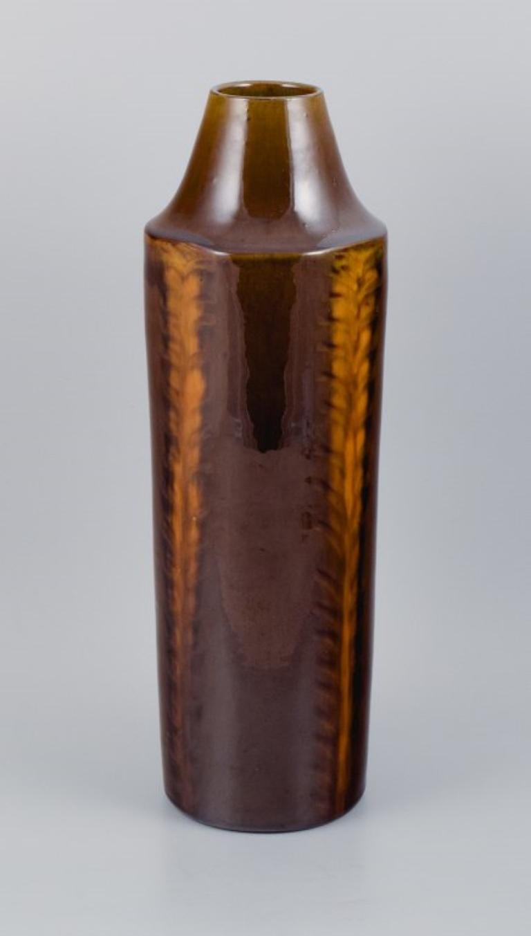 Jacob Bang (1932-2011) for Hegnetslund, Denmark. 
Large ceramic vase with beautiful glaze in light brown and orange shades.
Mid-20th Century.
In excellent condition.
Marked.
Dimensions: H 44.0 x D 12.5 cm.