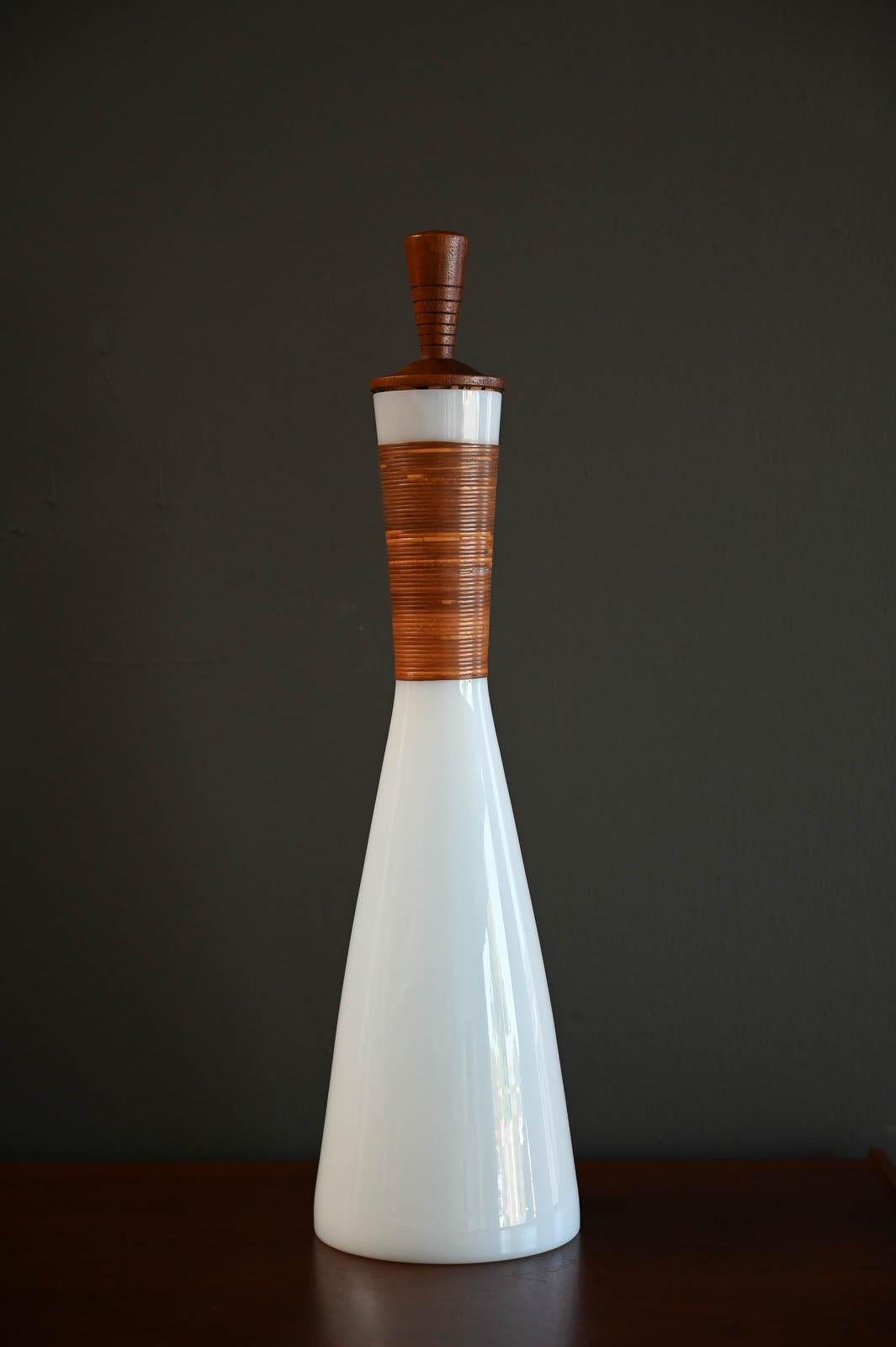 Jacob Bang for Kastrup White Opaline Glass Decanter, Raymor ca. 1960.  Beautiful original piece with no losses or heavy use.  Includes the original cork and teak stopper.  Stamped on underside.  

Measures 19