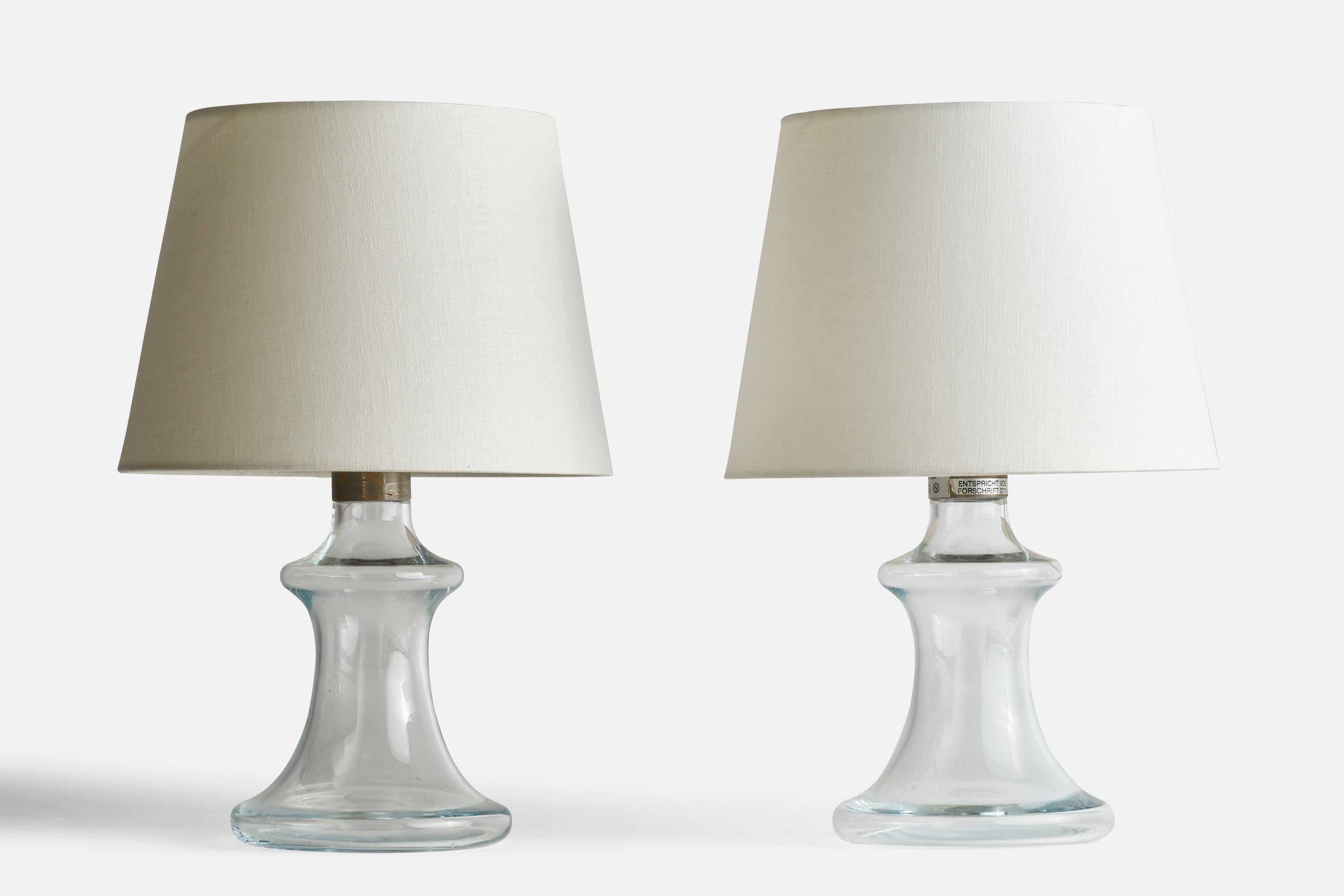 A pair of glass and metal table lamps designed by Jacob Bang and produced by Holmegaard, Denmark, c. 1970s.

Please note cord feeds from socket and runs visibly along base.

Dimensions of Lamp (inches): 12.5” H x 7” Diameter
Dimensions of Shade