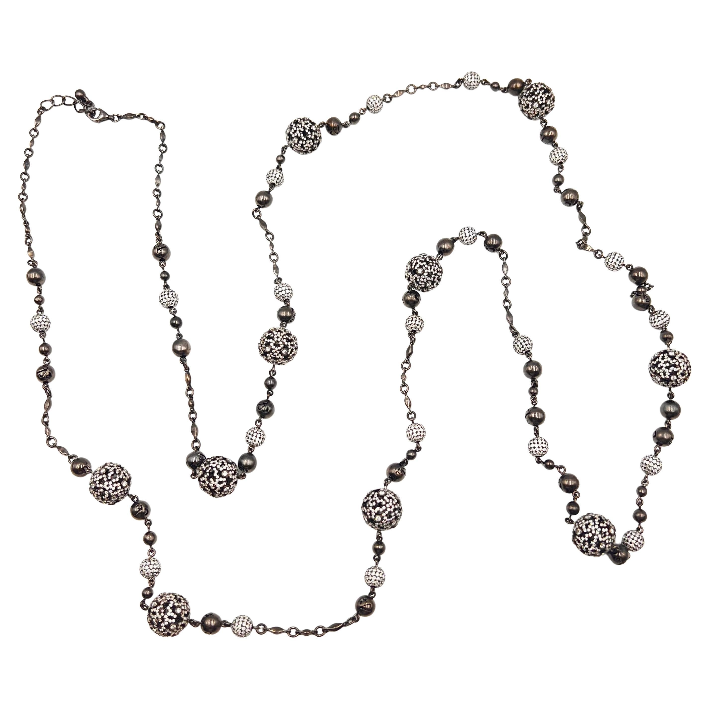Jacob & Co. Lace Collection ball long necklace crafted in 18k gold with black polished finish and pave-set with round brilliant-cut diamonds creating a stunning yet subtle effect.  Ten larger pierced, cut-out 12mm ball form beads and twenty smaller