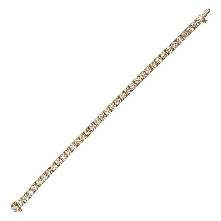 Jacob & Co. 18k yellow gold and diamond tennis bracelet.  Straight line design set with thirty-eight round brilliant-cut diamonds weighing approximately 12.92 total carats (H-J color, VS-SI clarity).  The diamonds are set in four prongs with each