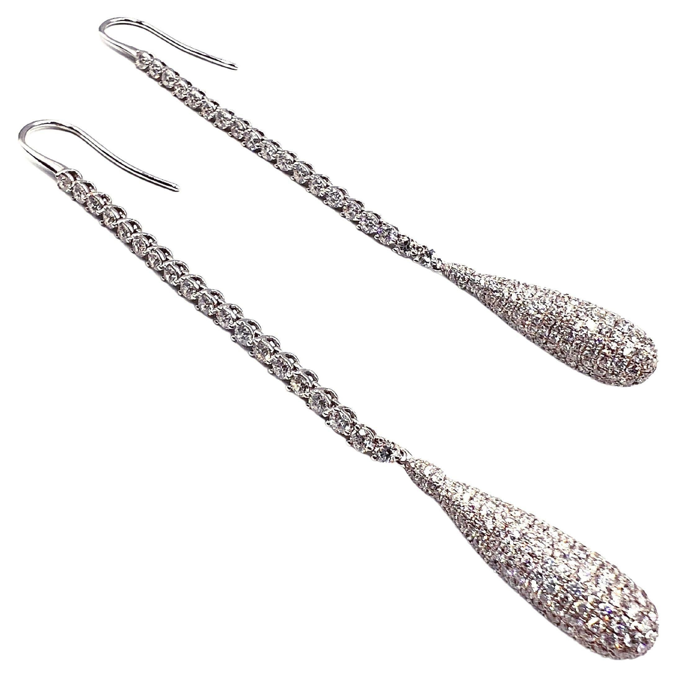 Long teardrop earrings designed by Jacob & Co. The tops are set with thirty-eight round brilliant cut diamonds weighing 2.38 total carats and the teardrop bottoms are pave-set with five hundred thirty-four round brilliant-cut diamonds weighing 4.03