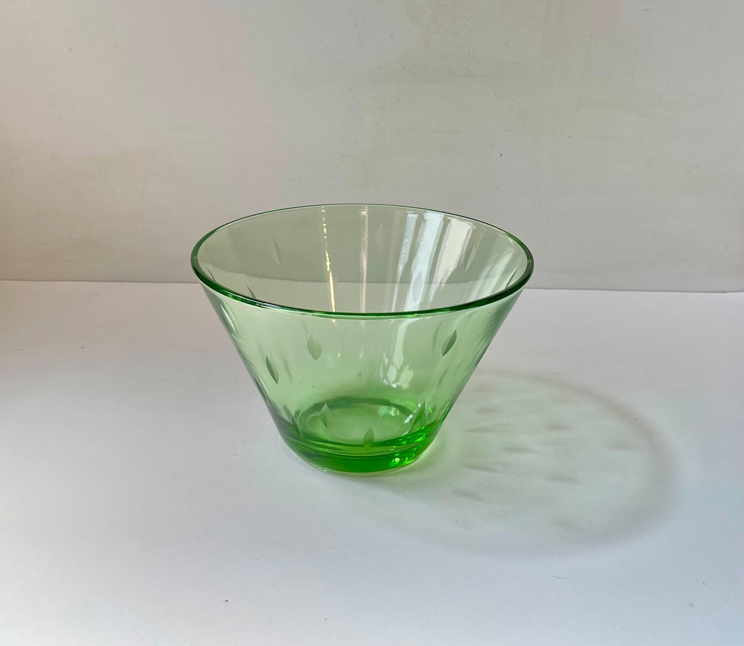 Exceptionally rare green uranium semi-conical glass bowl by Jacob E. Bang in his 'no name' art glass series for Holmegaard/Kastrup in Denmark circa 1935. It decorated with cut stylized arrows. A splendid piece for any functionalist or Art Deco