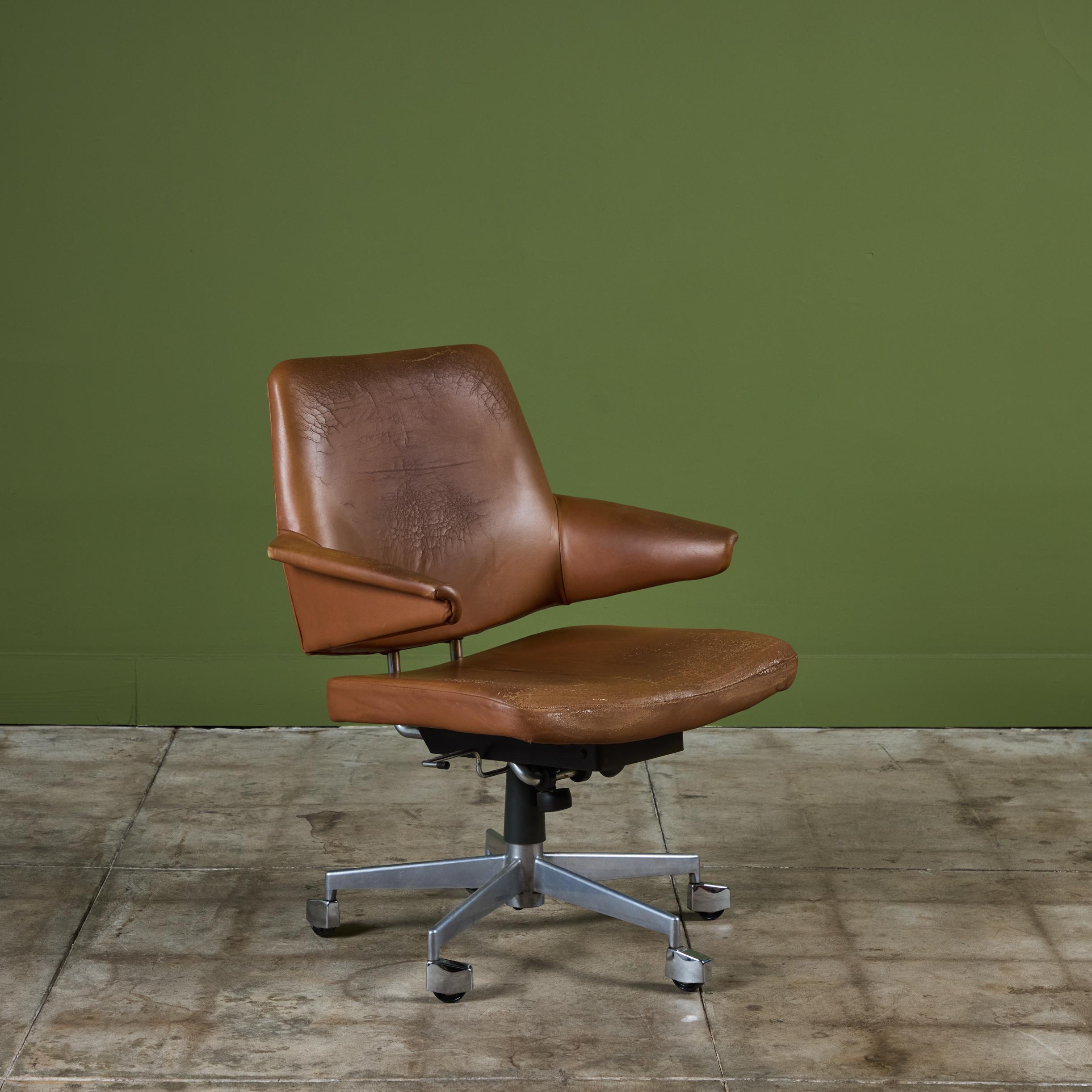 Leather desk chair by Jacob Jensen for Labofa, c.1960s, Denmark. This desk chair features the original brown leather upholstery and sits upon five metal casters.

Dimensions
26