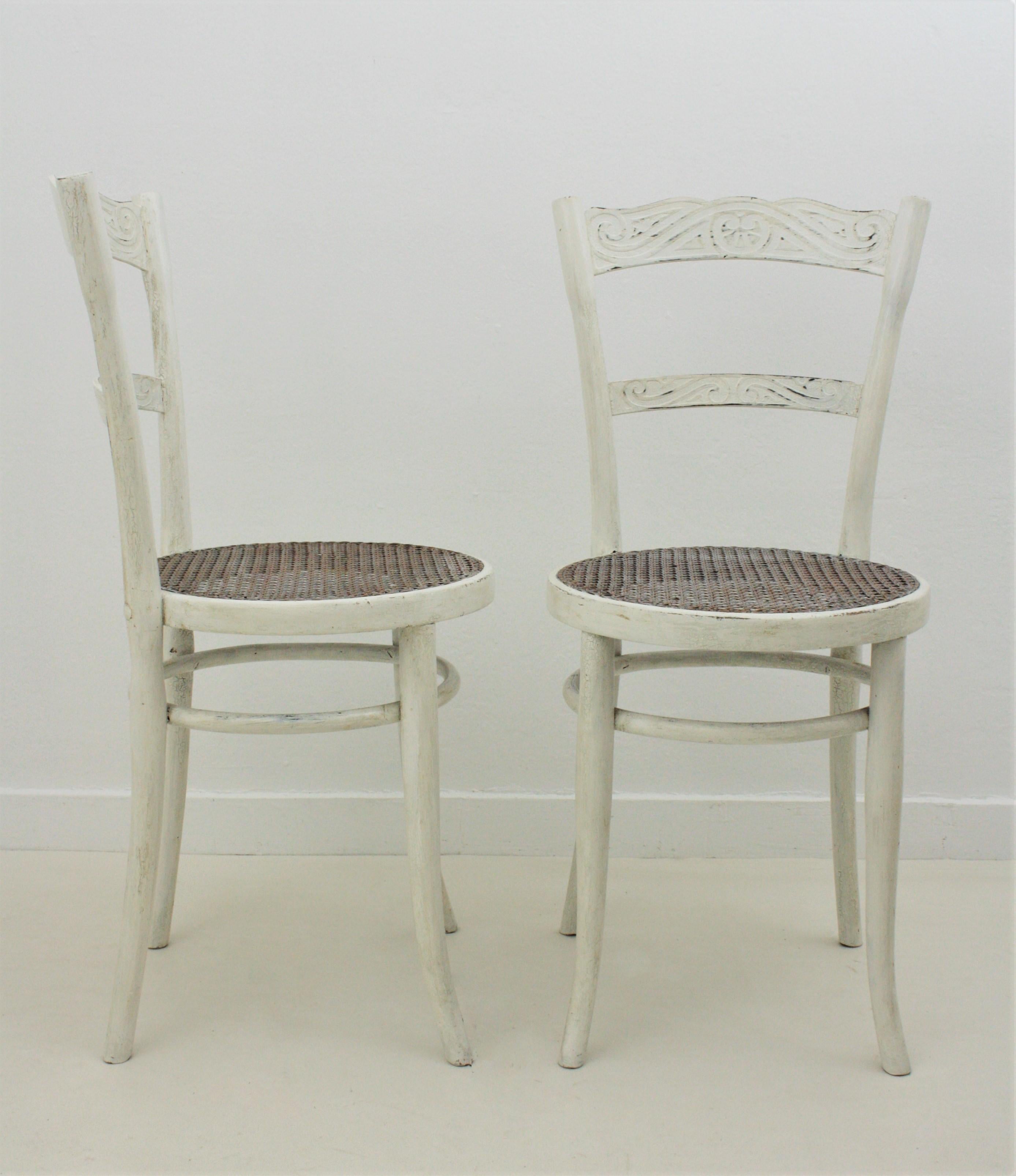 Beautiful pair of bentwood chairs patinated in white color with cane weave seats. Manufactured by J & J Kohn. Austria, 1900s.
Both are marked with the original manufacturers paper label. : Jacob and Josef Kohn, Austria. Number: 47
The chairs are