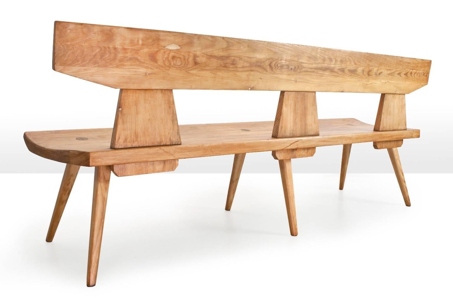 This Scandinavian modern 3 seater bench is definitely a text book example of the excellent Danish craftsmanship of the 1960s. This listed solid pine wooden bench was designed by the outstanding cabinetmaker Jacob Kielland Brandt in the 1960s for