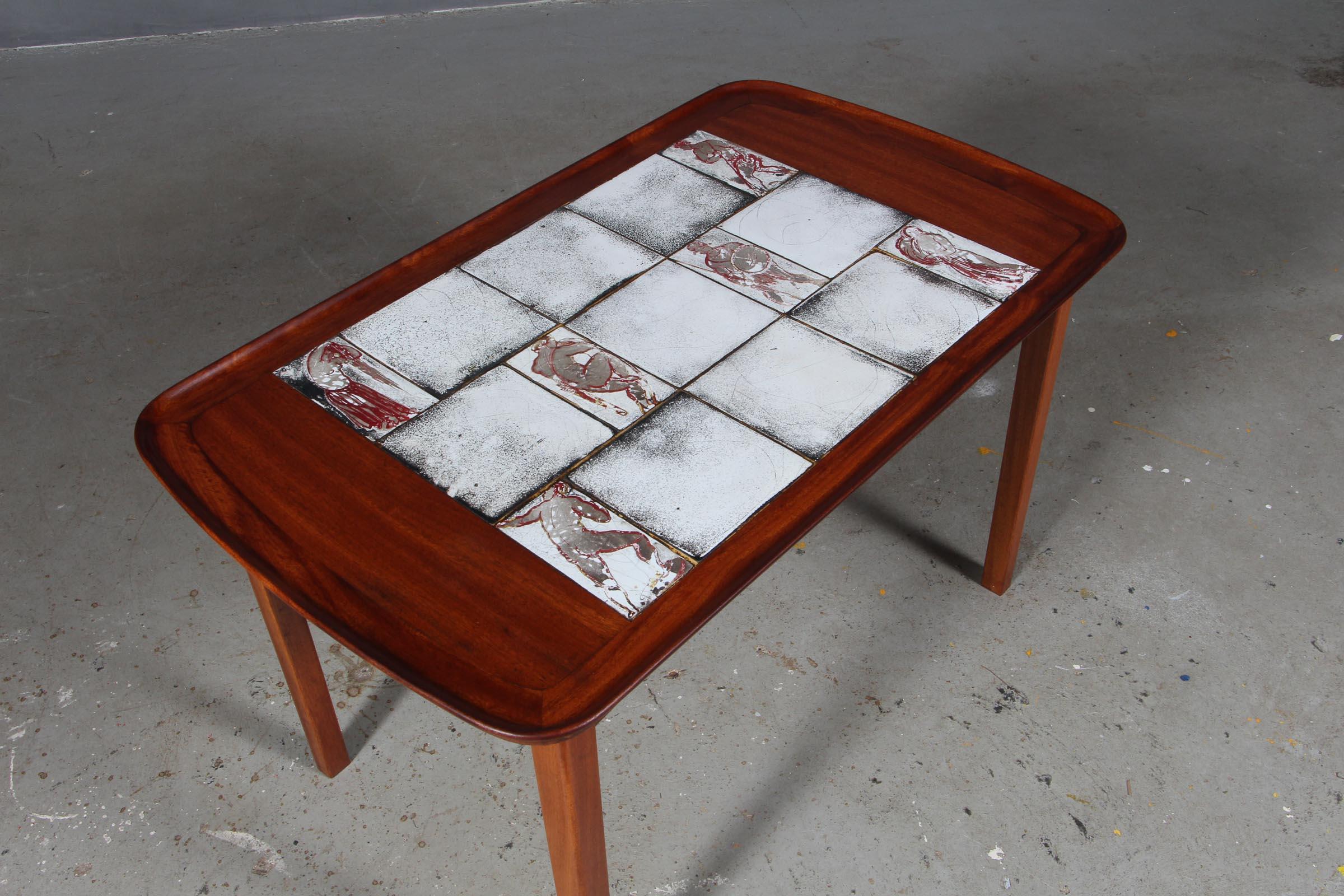 Jacob Kjær coffee table.

Made of solid cuban mahogany. Tiles By Jens Thirslund from Kähler.

Made by Jacob Kjær.