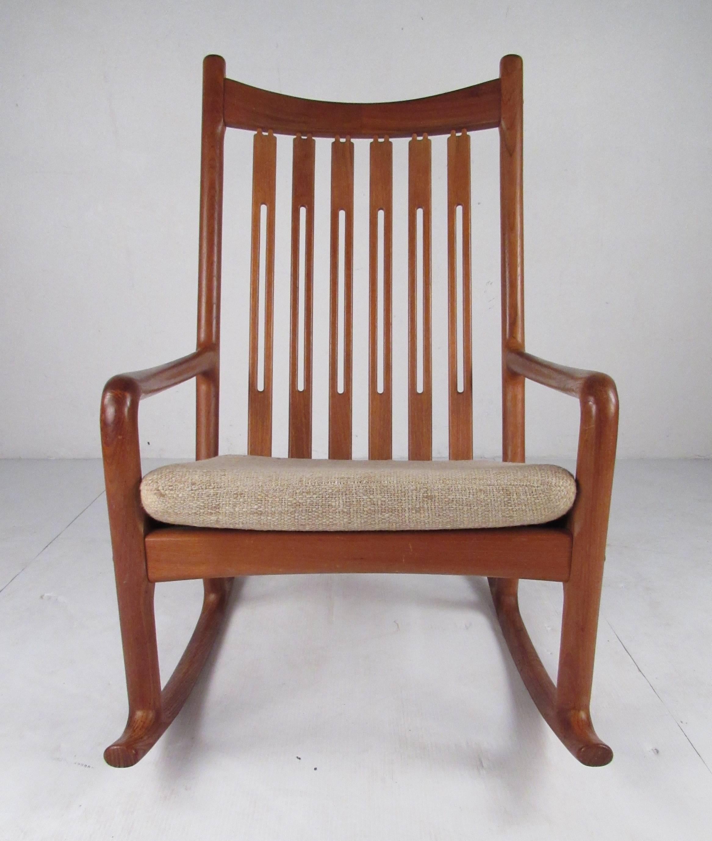 Beautifully constructed Danish modern rocking chair in solid teak. Comfortable and in very good vintage condition, stylish high back rocker perfect for seating in any mid-century or Scandinavian modern styled interior. Please confirm item location