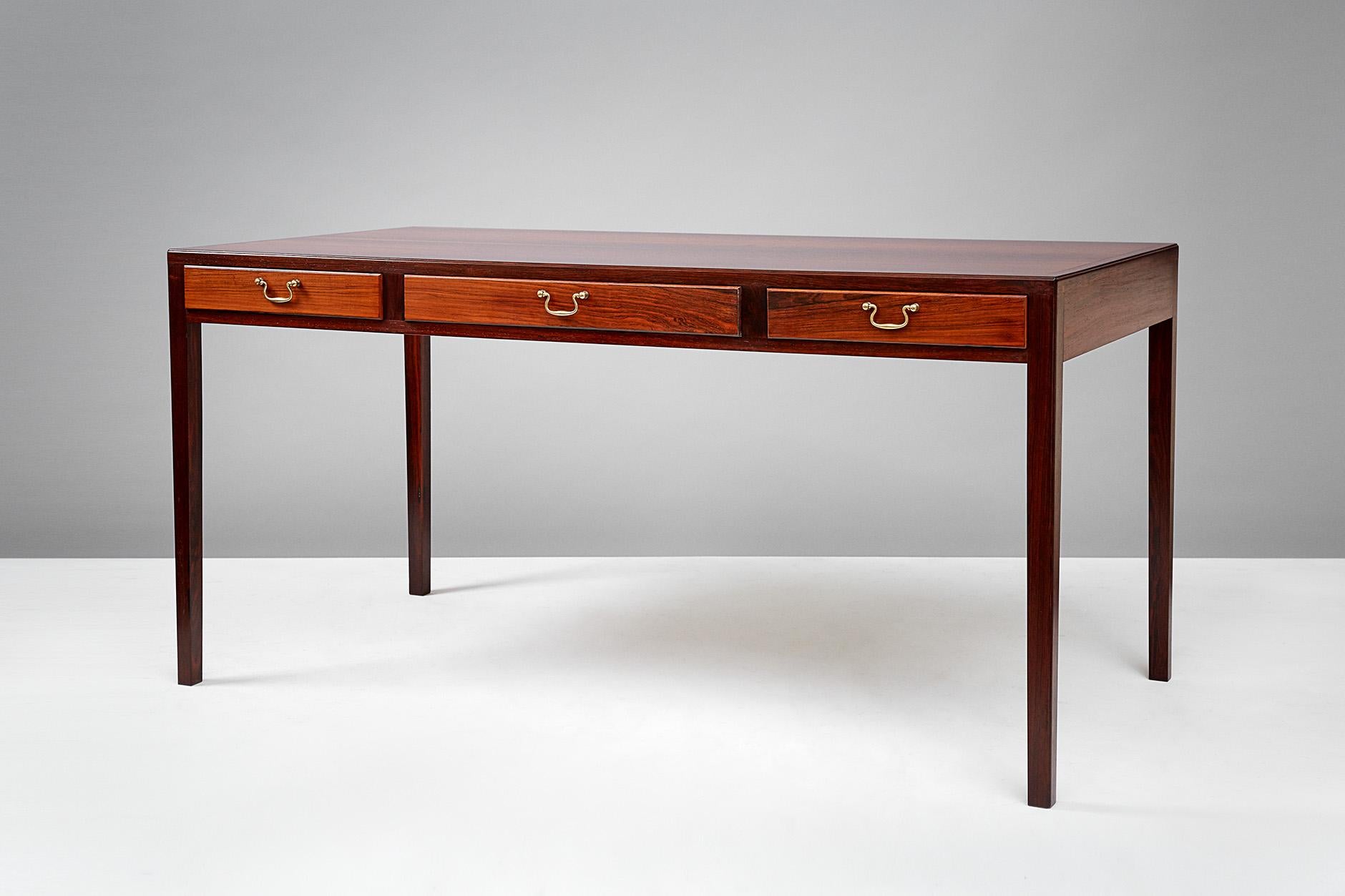 Jacob Kjaer

Writing desk, circa 1950s

Desk made from Brazilian rosewood by master Danish cabinetmaker Jacob Kjaer. Three integral drawers with solid brass hardware.