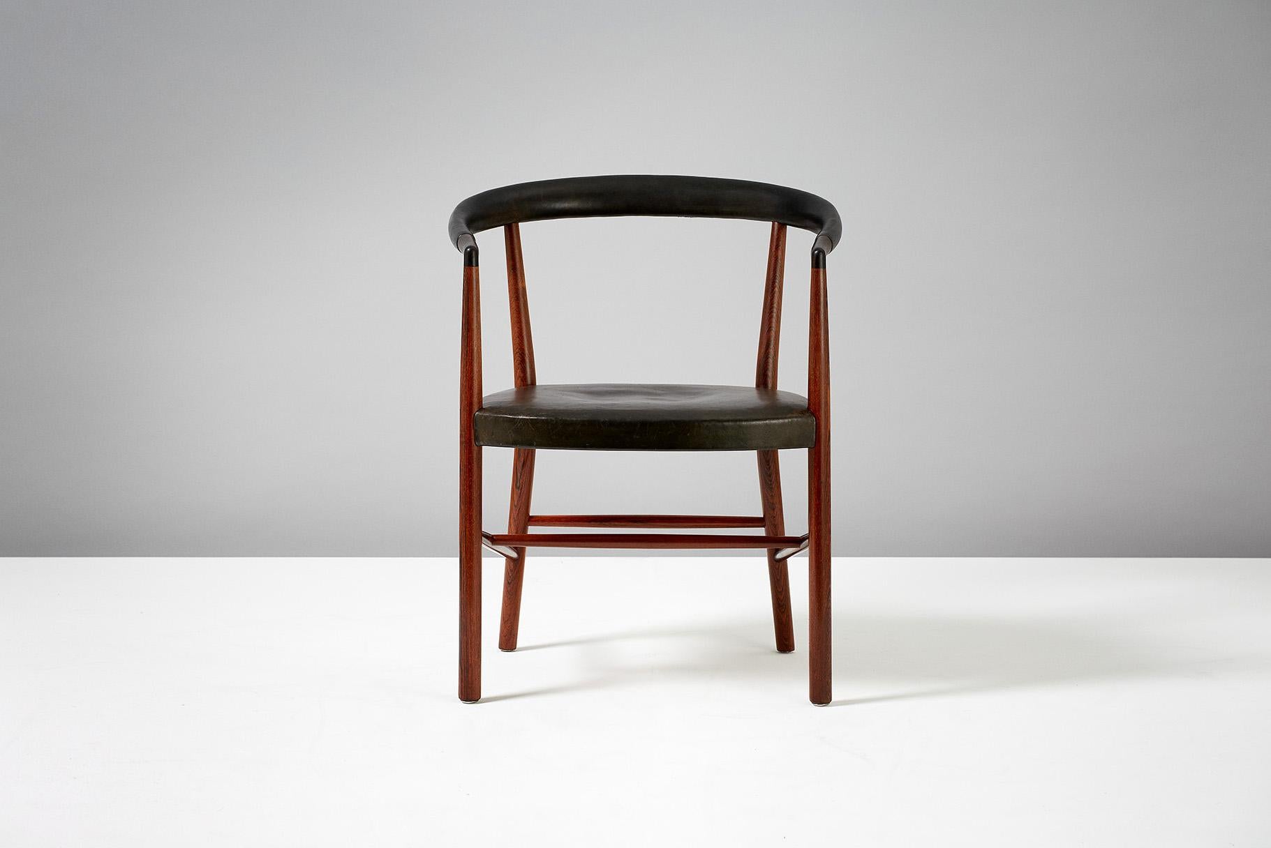 Jacob Kjaer 

UN Chair, 1949

Model B-37 armchair designed in 1949 for the UN headquarters in New York. Produced in Brazilian rosewood with seat and back upholstered with original black patinated leather. This example made approximately
