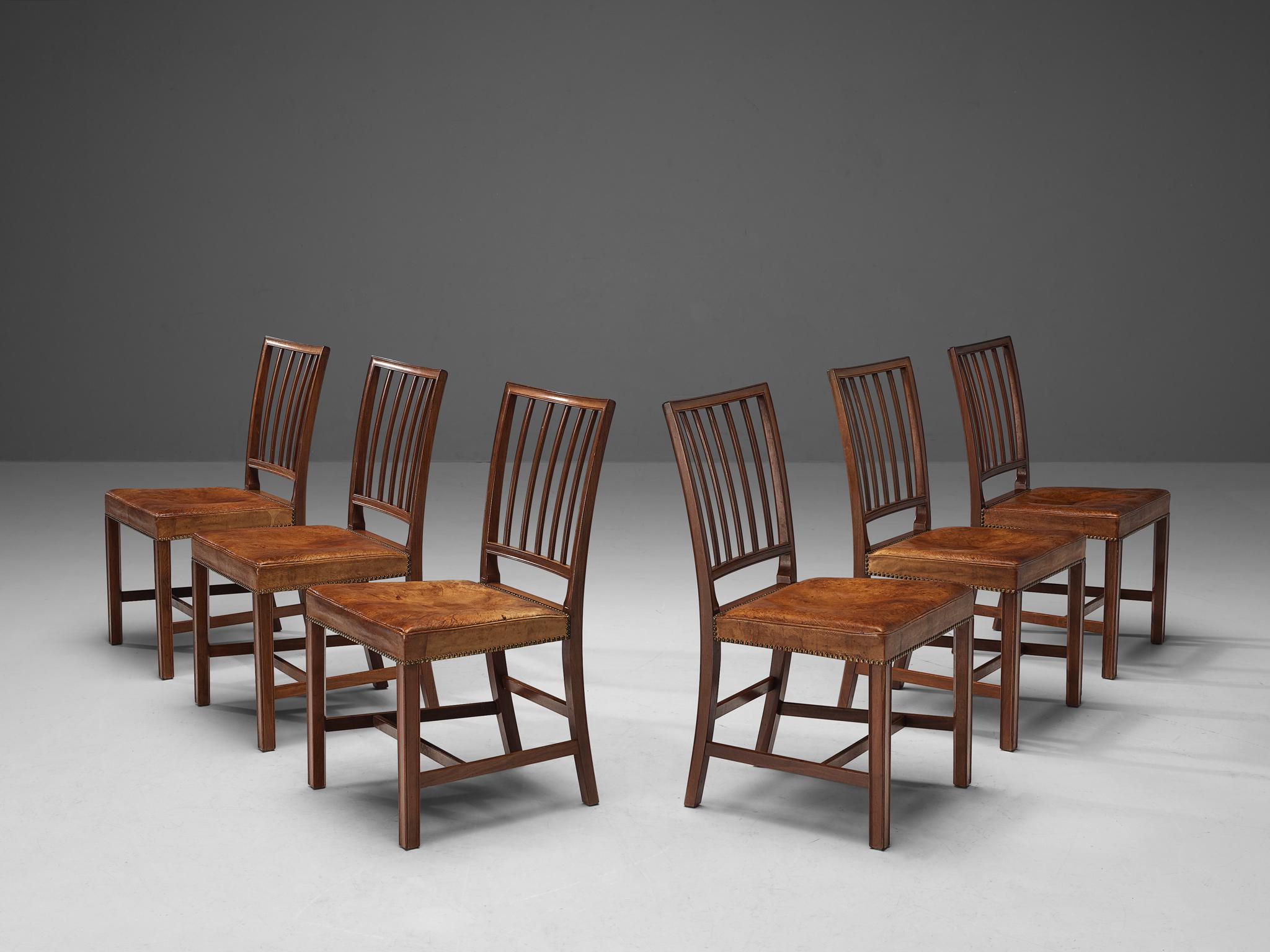 Jabob Kjær for Jacob Kjær Møbelhaandværk, dining chairs, niger leather, cuban mahogany, brass rivets, Denmark, 1937.

Stunning set of dining chairs by Jacob Kjær manufactured in 1937. The Danish designer Jacob Kjær was creating this particular model