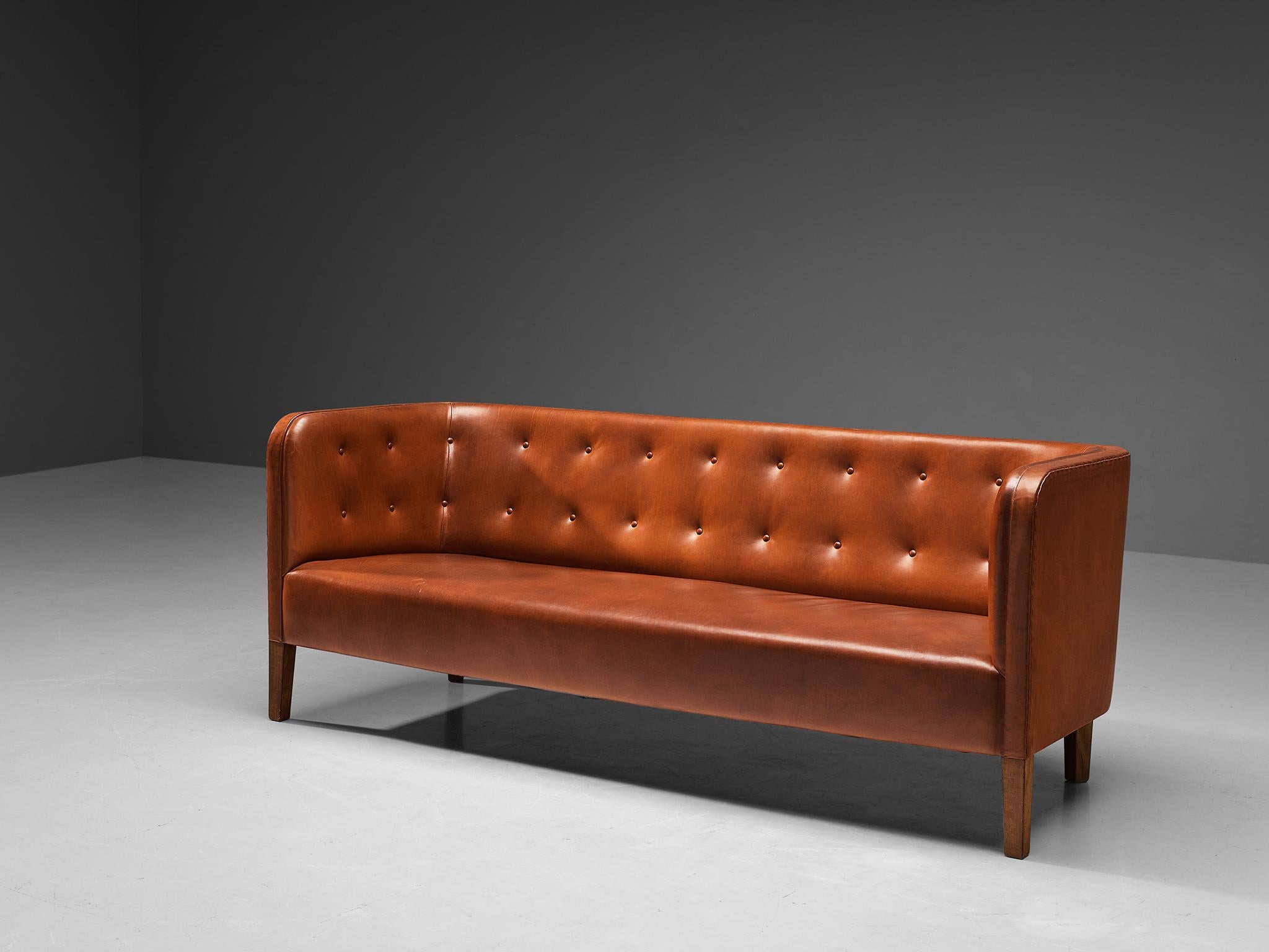 Attributed to Jacob Kjaer, Sofa, leather, mahogany, Denmark, 1940s

This sofa is attributed to the Danish cabinetmaker Jacob Kjaer. The design truly intensifies the experience of sitting by means of the impressive construction featuring delicate