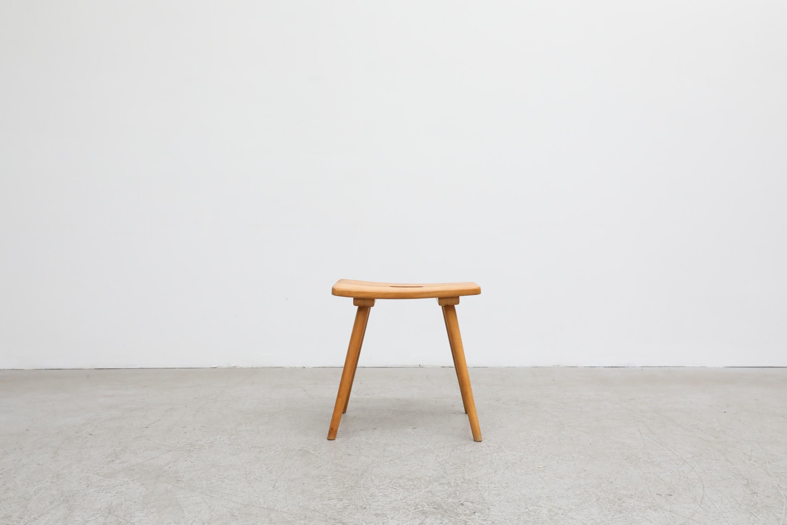 Jacob Muller For Wohnhilfe maple stool with cut-out top. In original condition with visible wear consistent with its age and use.