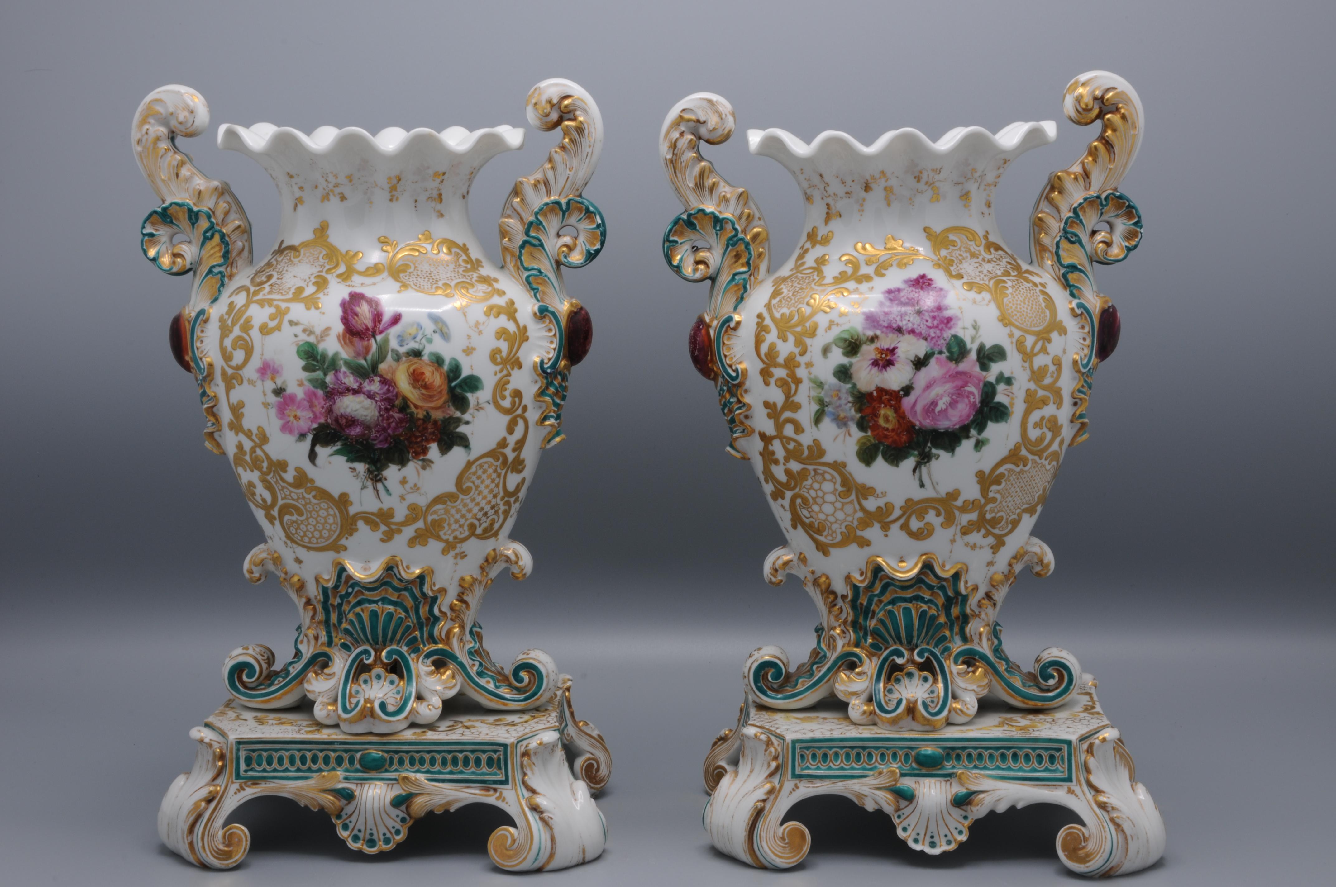 Very ornate pair of French romantic vases by Jacob Petit, Paris 
Baluster form, heavy white porcelain vases on stands with floral sprays within a raised and gilt acanthus scoll and shell border continuing to outward scroll handles and raised on four