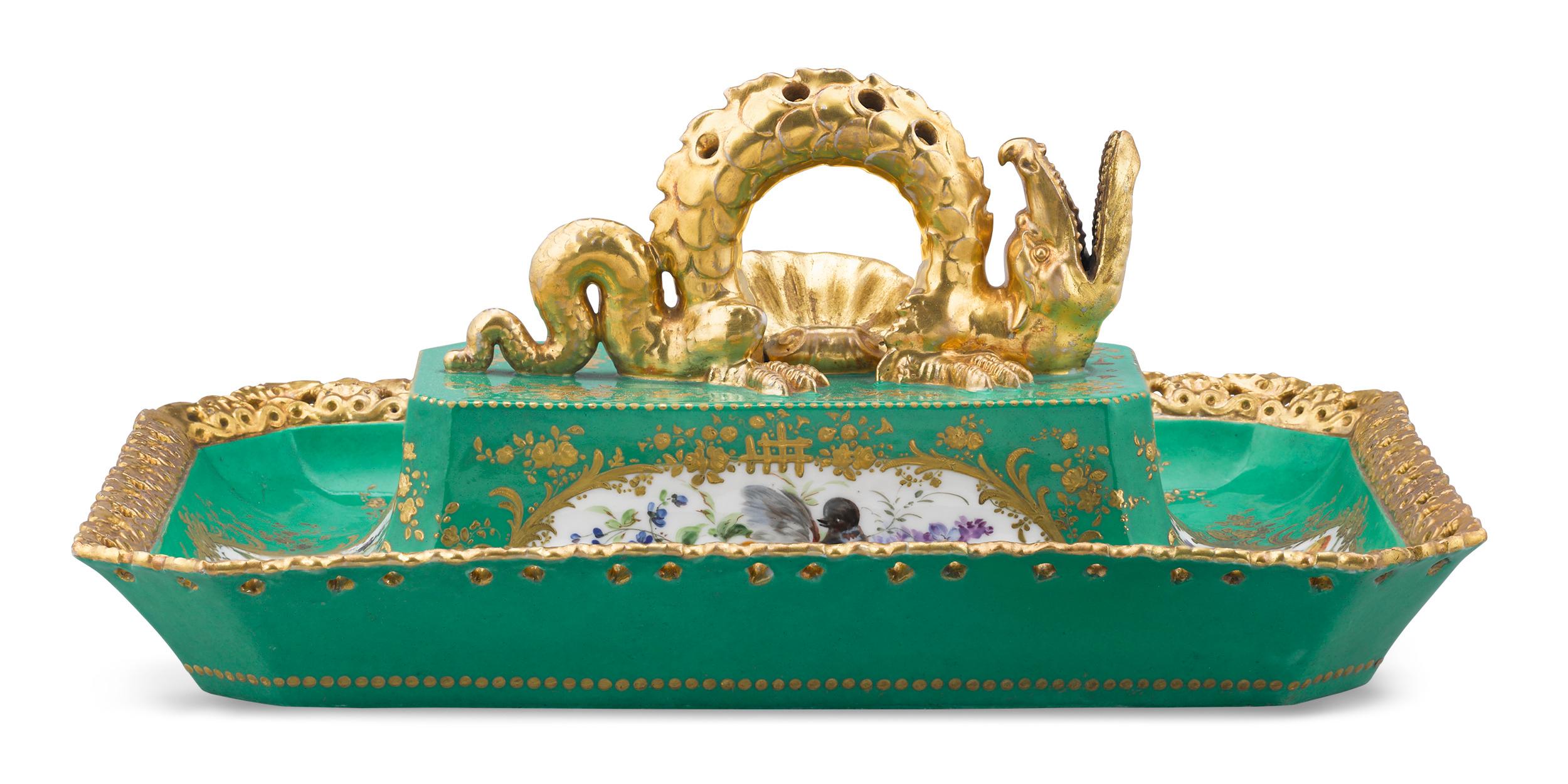 This richly decorated tray was created by celebrated French porcelain manufacturer Jacob Petit. Topped by an impressive gilt Chinese dragon, the piece is distinguished by finely hand-painted scenes depicting songbirds and floral arrangements against