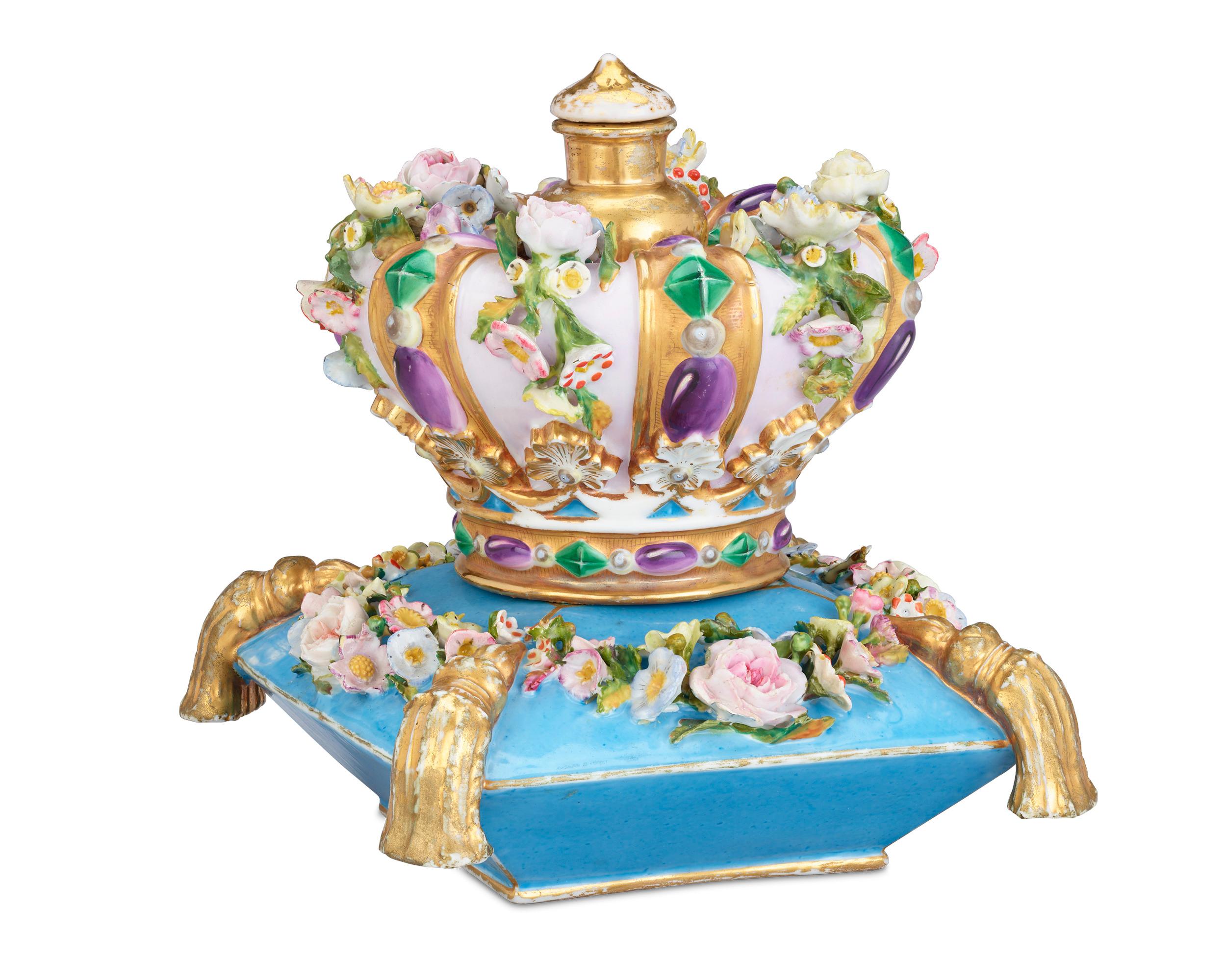 A crown tops this regal perfume bottle crafted by Jacob Petit, one of the most important and well-known makers of French porcelain. The crown is decorated with gems and flowers delicately formed from porcelain and rests upon a plump blue cushion