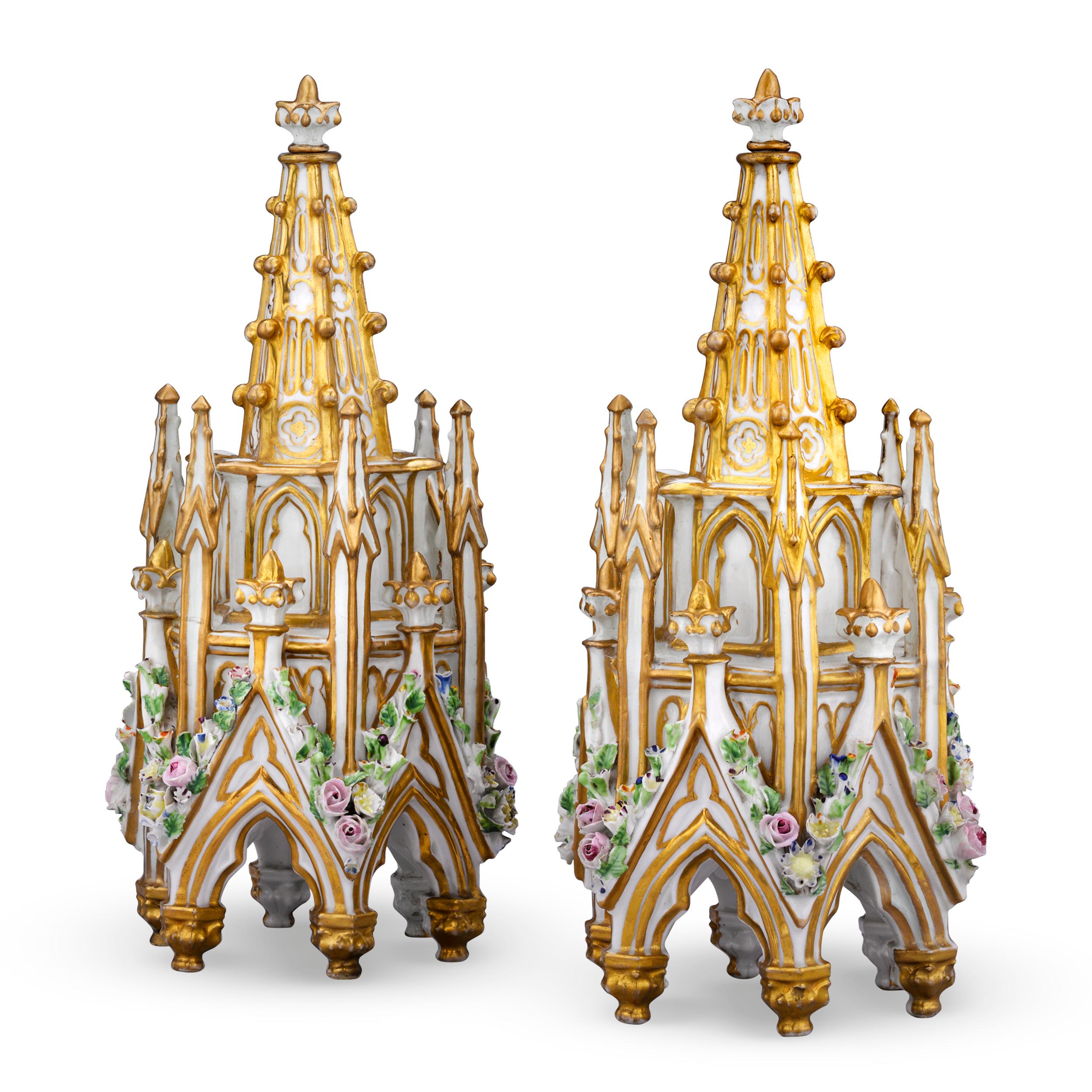 These striking perfume bottles were crafted by renowned French porcelain artist Jacob Petit. The pair's highly unique hexagonal spire form brings to mind the architecture of a Gothic cathedral. Encrusted with colorful hand-painted flowers against a