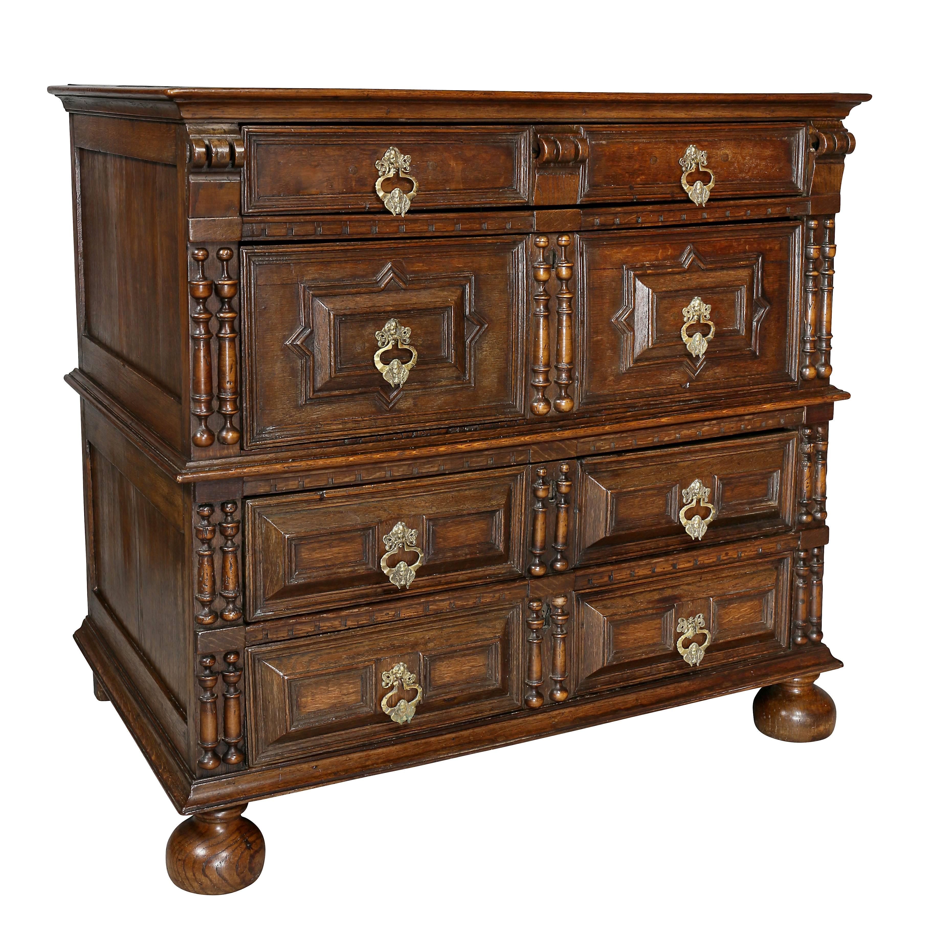 Rectangular top over four drawers with applied split balusters, raised on bun feet.