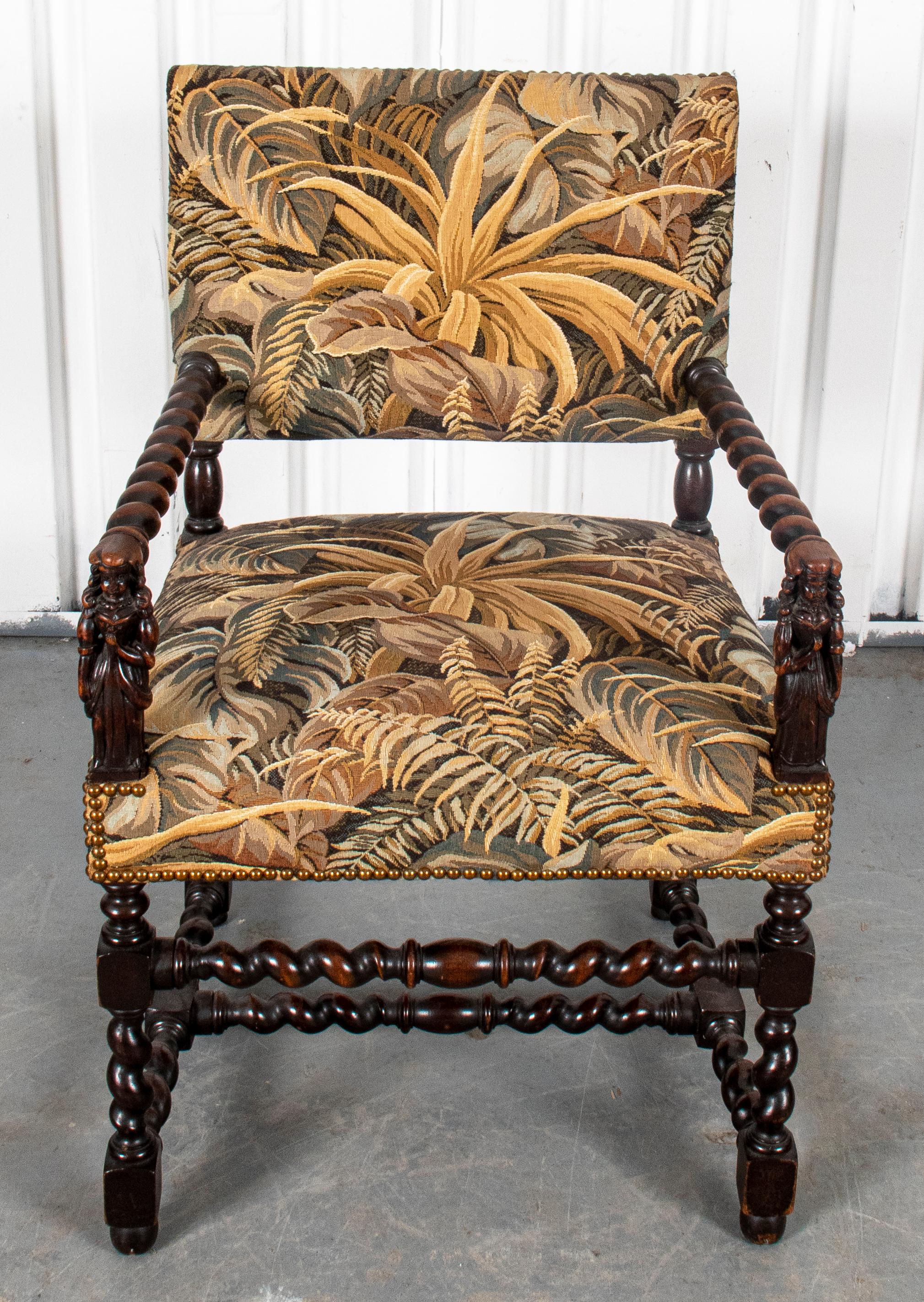 Jacobean Revival open frame armchair with carved figural arm rests, barley twist legs, and tapestry upholstered seat and back. 36