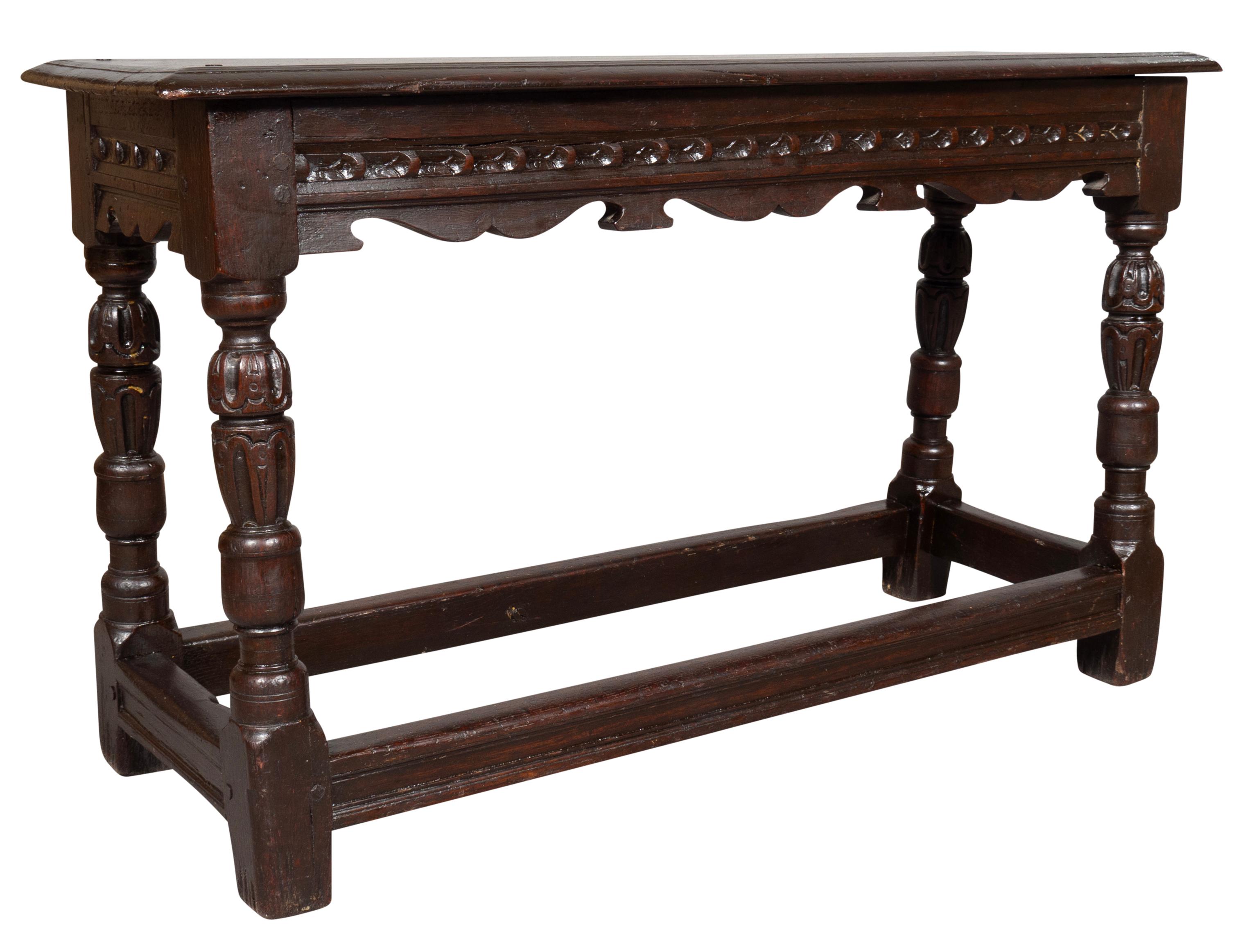 Comprising early elements and well executed and authentic looking with a rectangular top over a carved frieze. Turned carved legs with a box stretcher.