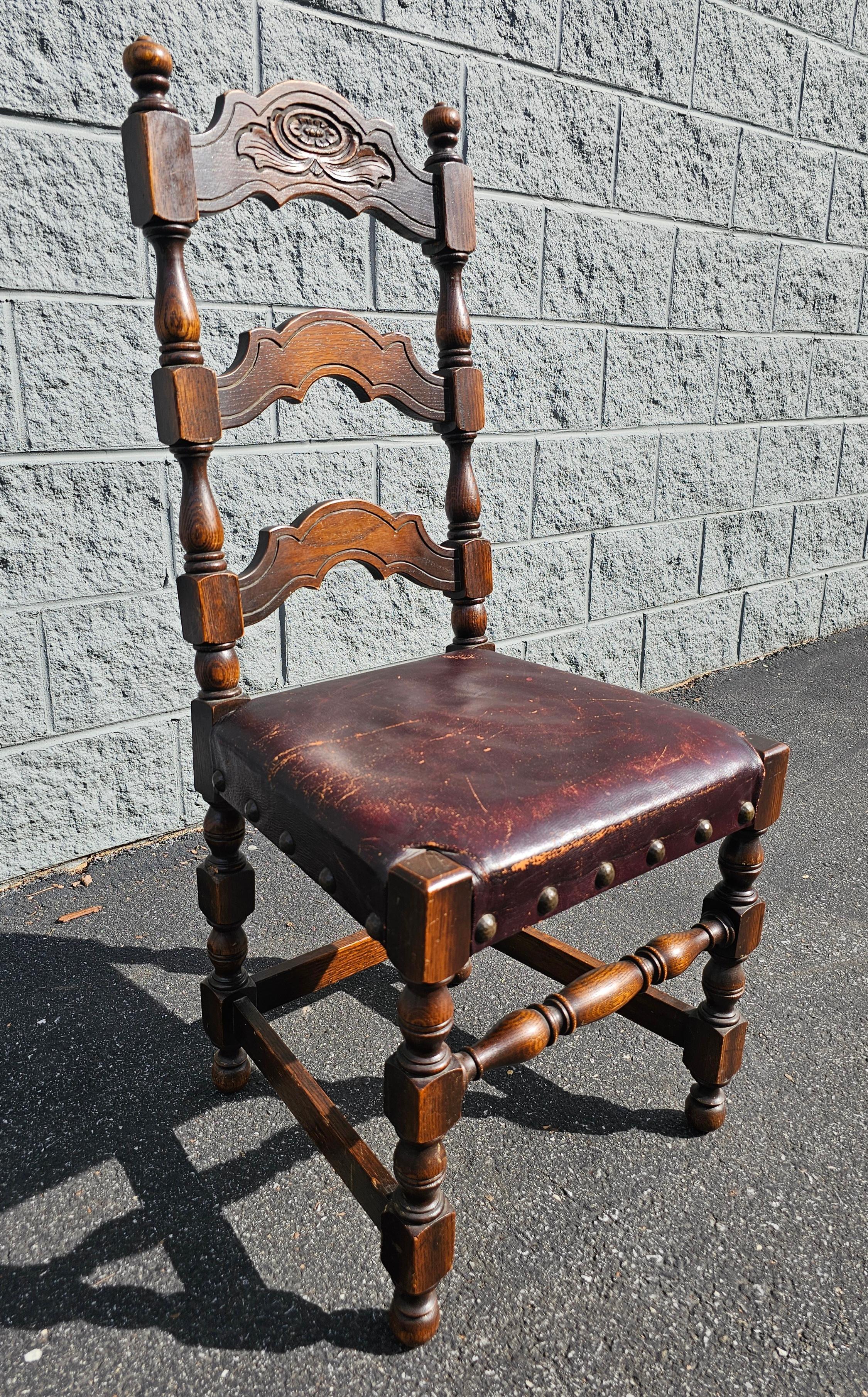 A Jacobean Revival Style Leather Upholstered Oak Side Chair, late 19th to early 20th Century. Measures 18