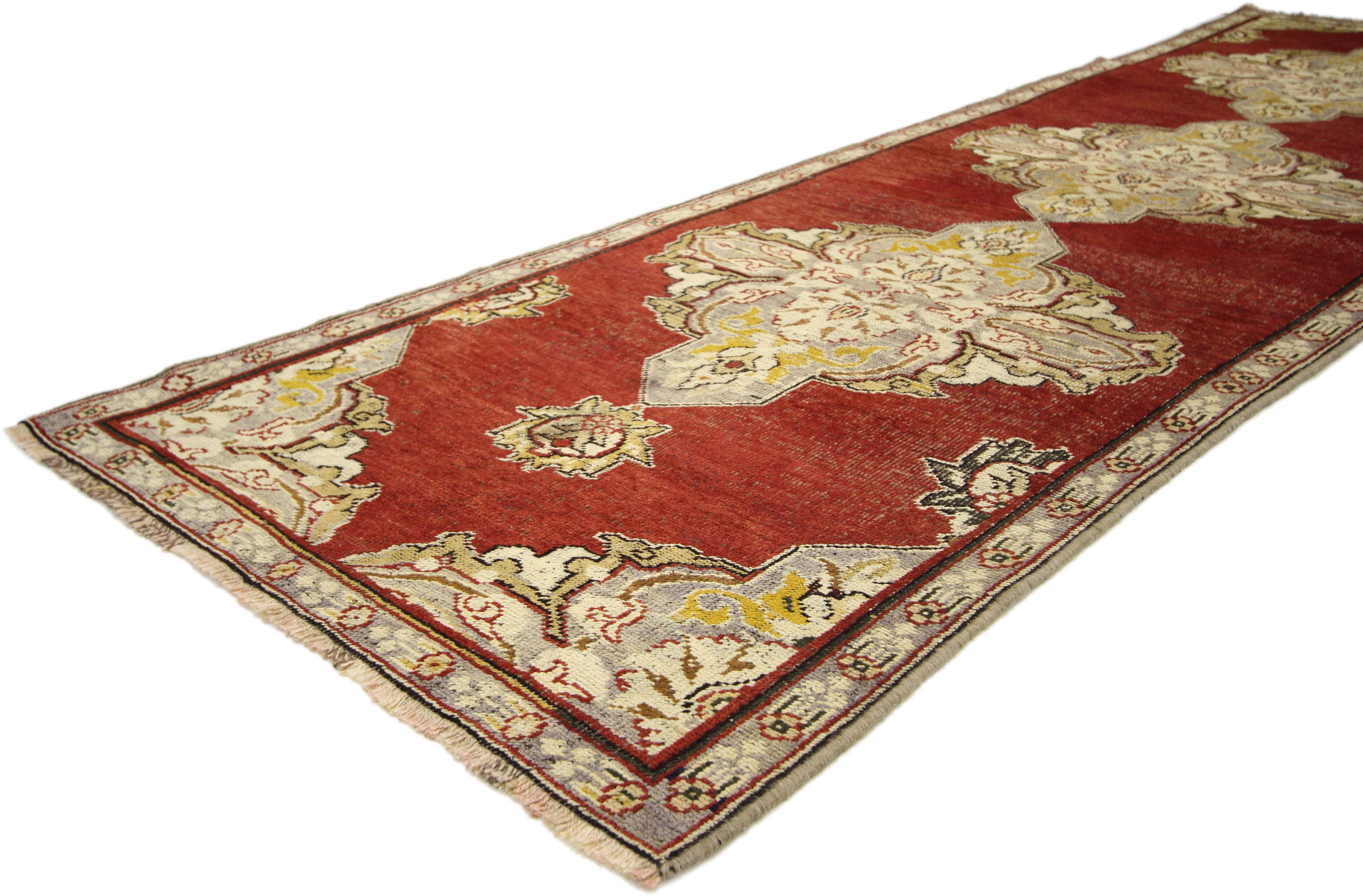 50227, Jacobean style antique Turkish Oushak Hallway runner. This hand knotted wool antique Turkish Oushak hallway runner features three intricate stylized amulet medallions in an abrashed field capped on the ends with two lush palmettes. The