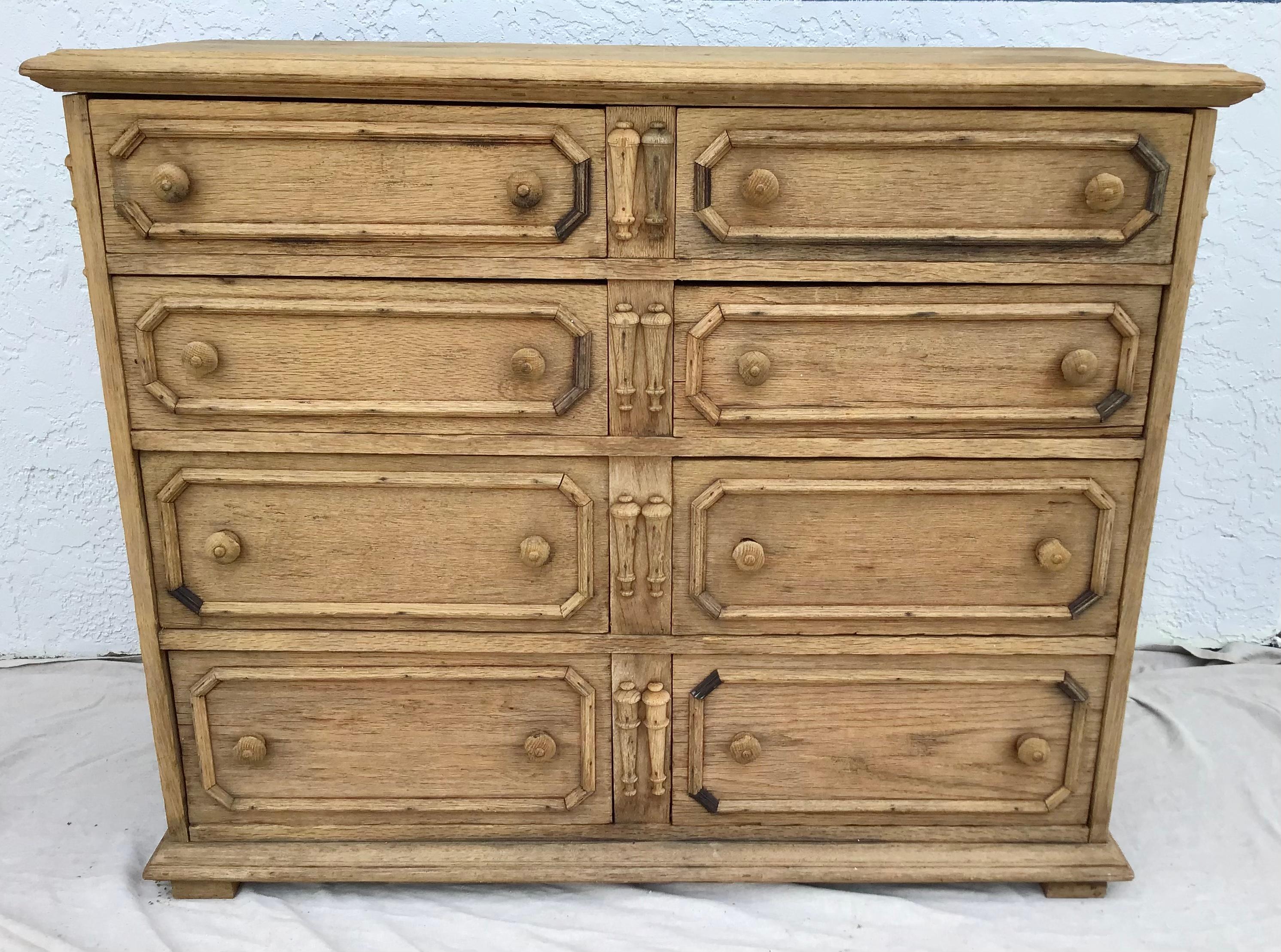 This is a beautiful English Jacobean style chest constructed using oak and pegged construction during the late 19th century with two rows of drawers. 8 total drawers. In a wonderful, bleached finish.