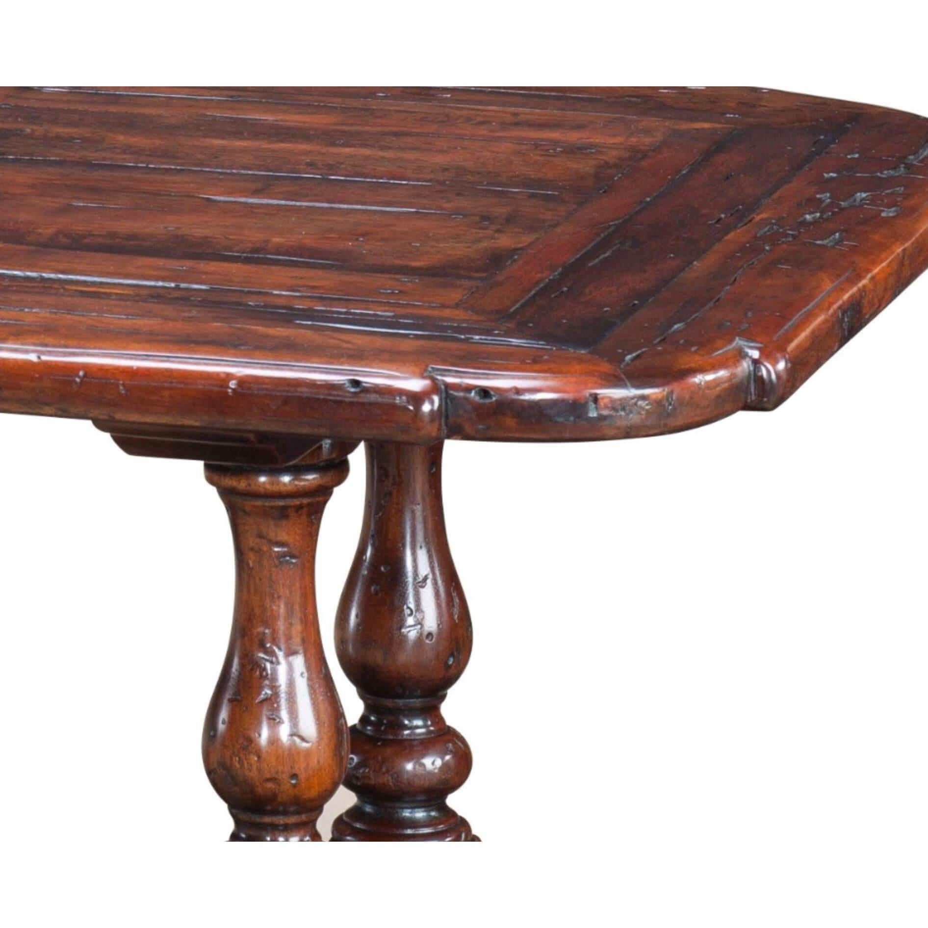 An antiqued wood cocktail table, the rounded re-entrant corners above double turned end balusters joined by a pegged stretcher. The original 17th century.

Dimensions: 60