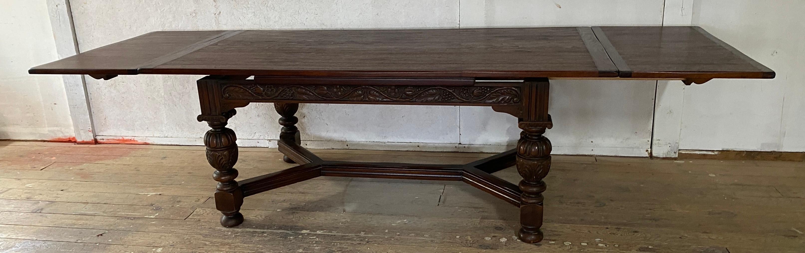 The refectory table has boldly gadrooned frieze, raised on massive cup and cover legs terminating in blocks joined by stretchers. The two additional pull out leaves helps to extend the table to 10' long accommodating 10. 
Beautiful oak top Perfect