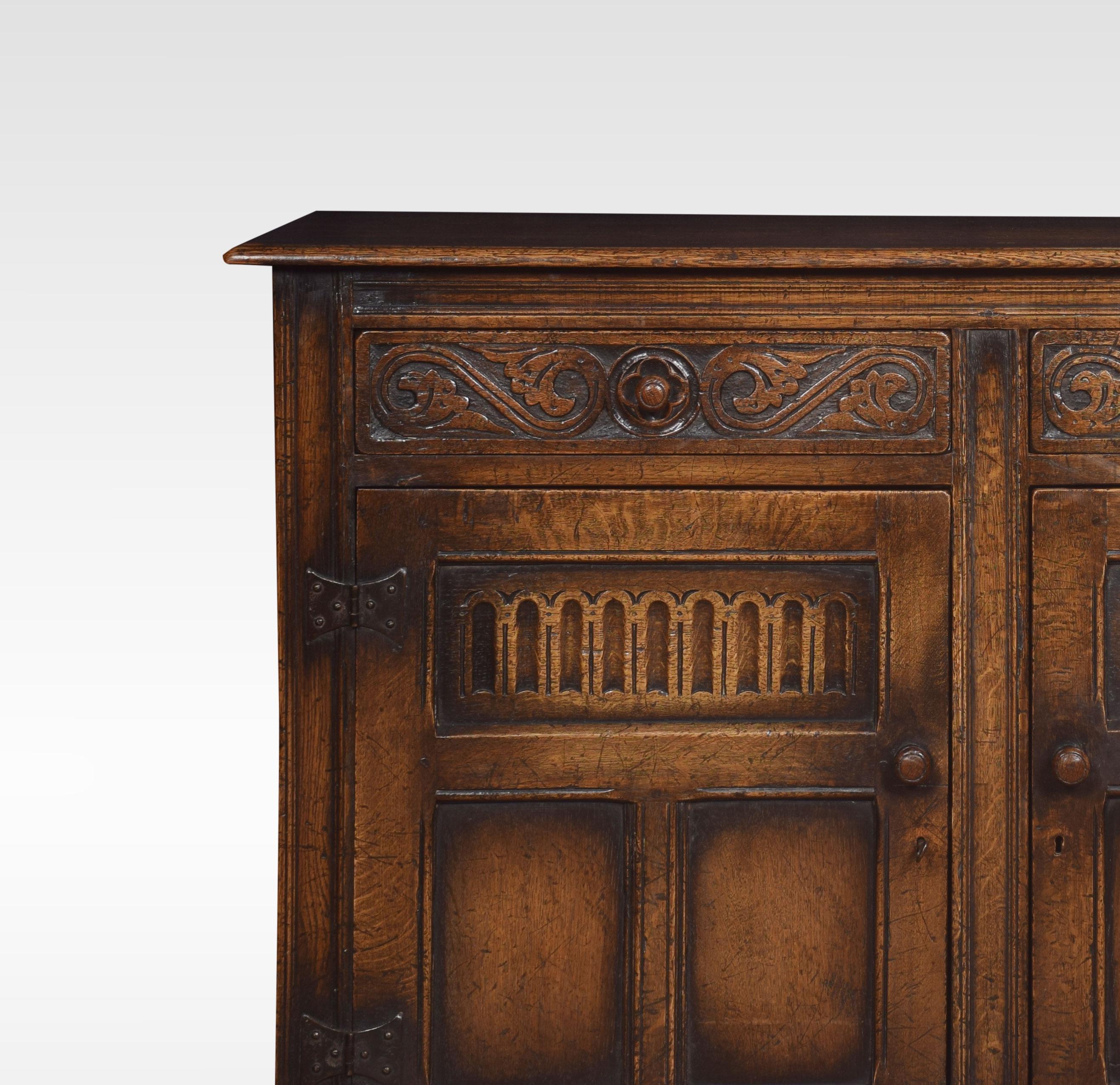 Jacobean style oak cupboard, the large rectangular top to the frieze fitted with two drawers above two carved paneled doors opening to reveal a large storage area. All raised up on style feet.
Dimensions:
Height 34.5 inches
Width 48 inches
Depth