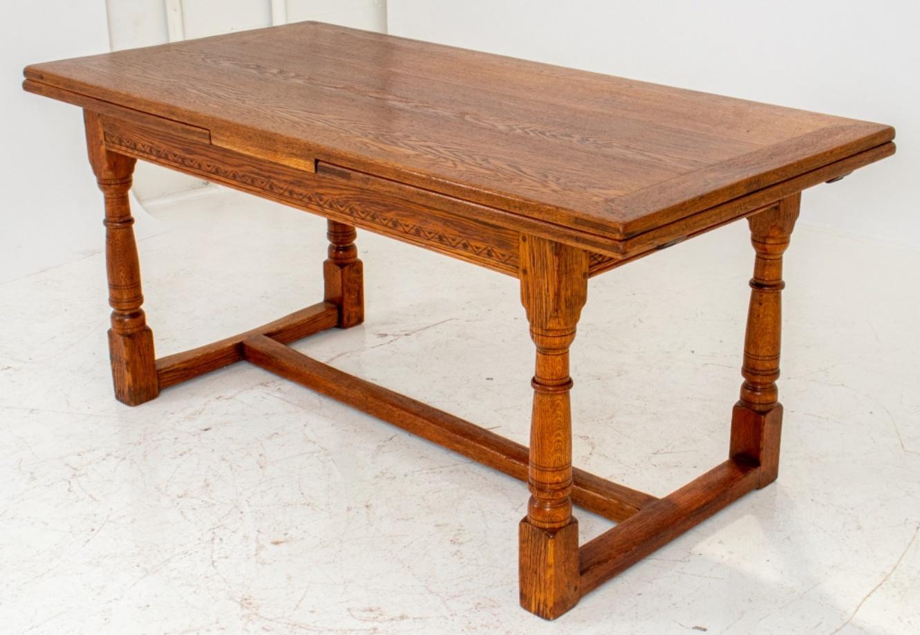 Oak refectory style dining table, in the Jacobean style rectangular with extending mechanism beneath top, above four turned legs connected by stretchers. 30.5