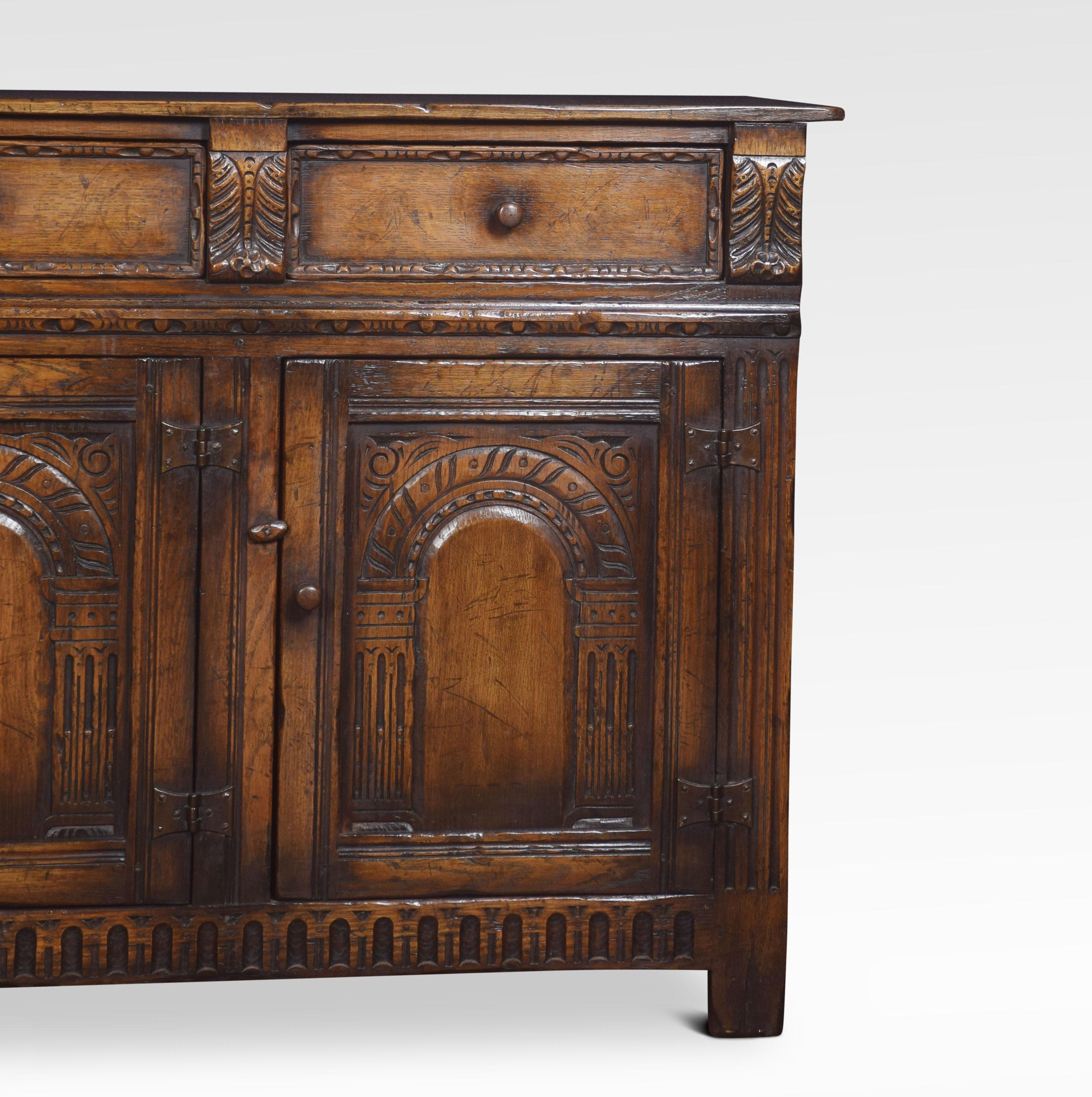 Jacobean style oak dresser base, the large rectangular top to the frieze fitted with three drawers above three-paneled and fluted doors opening to reveal a large storage area. All raised up on style feet.
Dimensions
Height 36 inches
Width 66