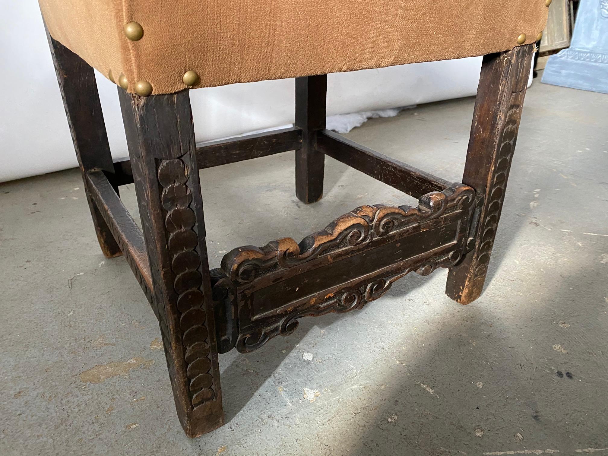 Jacobean style side chairs having a rectangular padded back and seat, raised on straight legs joined by carved stretchers with nail head trim over velvet fabric, 
This chair would work well in Spanish Renaissance Revival style decor, Spanish,