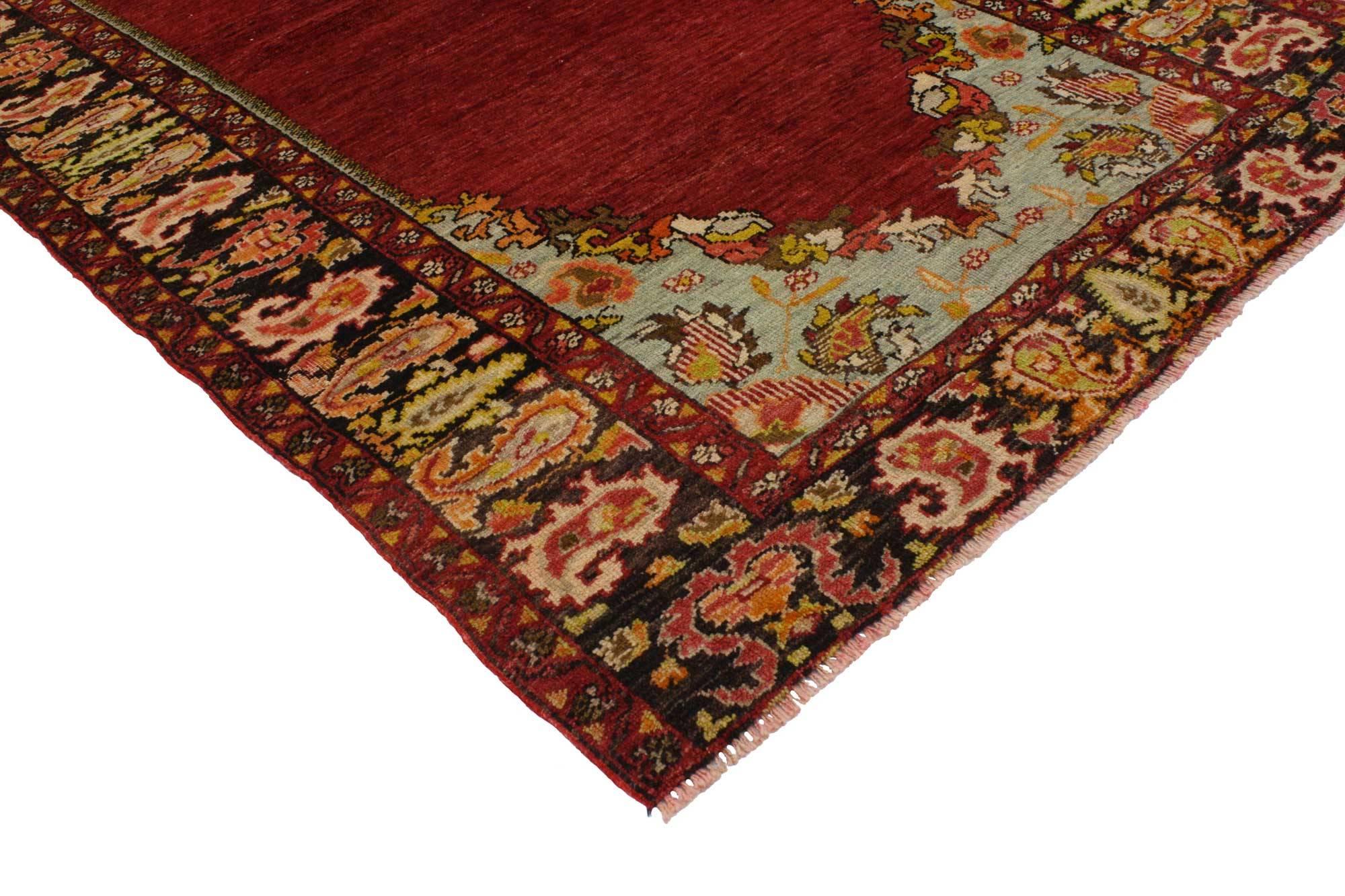 51656 Jacobean style vintage style Oushak rug, entry or foyer rug. A cloud-band border composed of pistachio color cypress trees and jagged edge boteh motifs surround an abrashed field of striated ruby red and crimson in this impressive Oushak