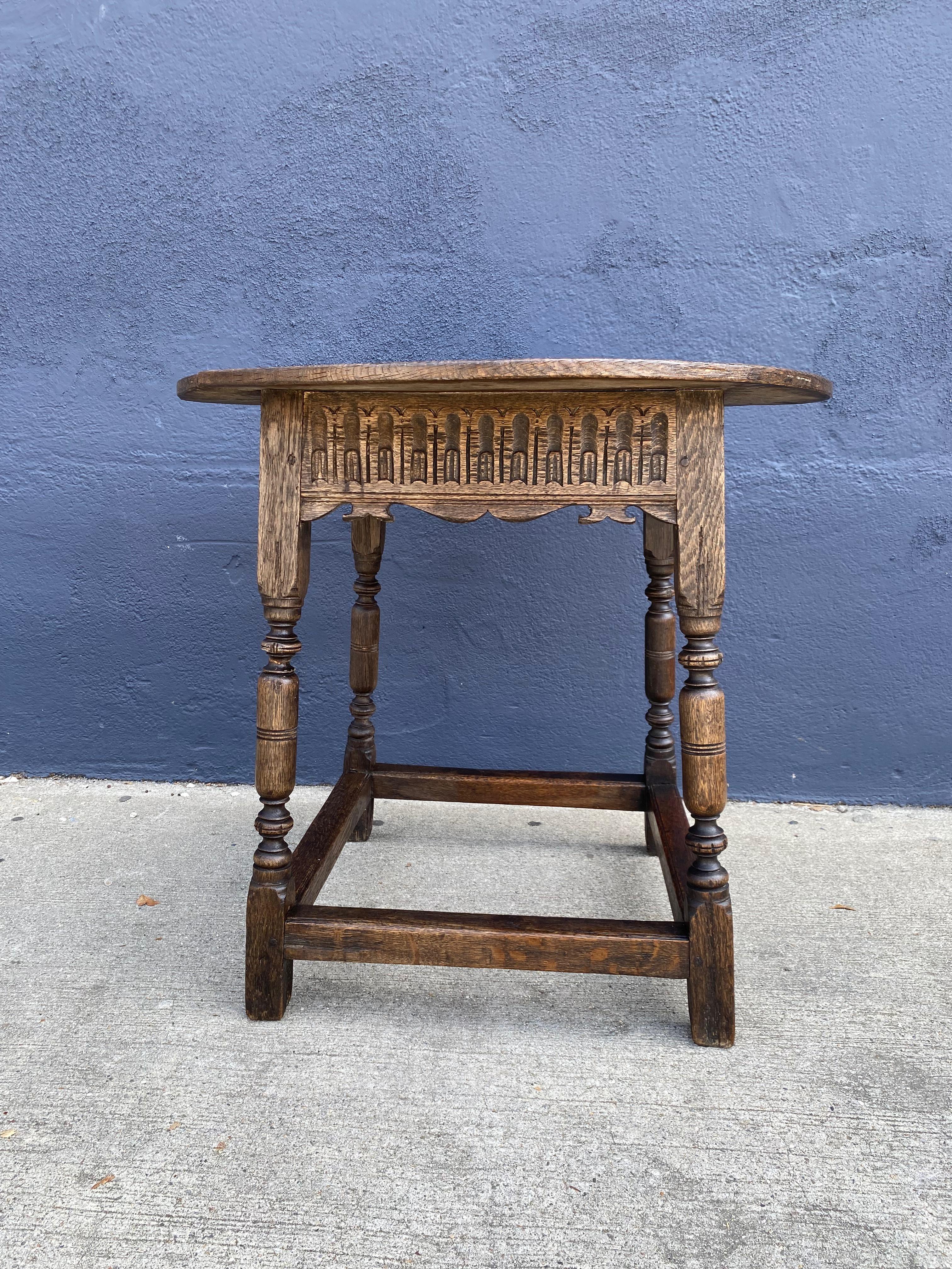 This is a very good example of a late Jacobean carved oak Tavern table. The generous 30 inch round top is an unusual feature as the majority of tavern tables were of square or rectangular form. The table was at one point in its life ebonized; traces