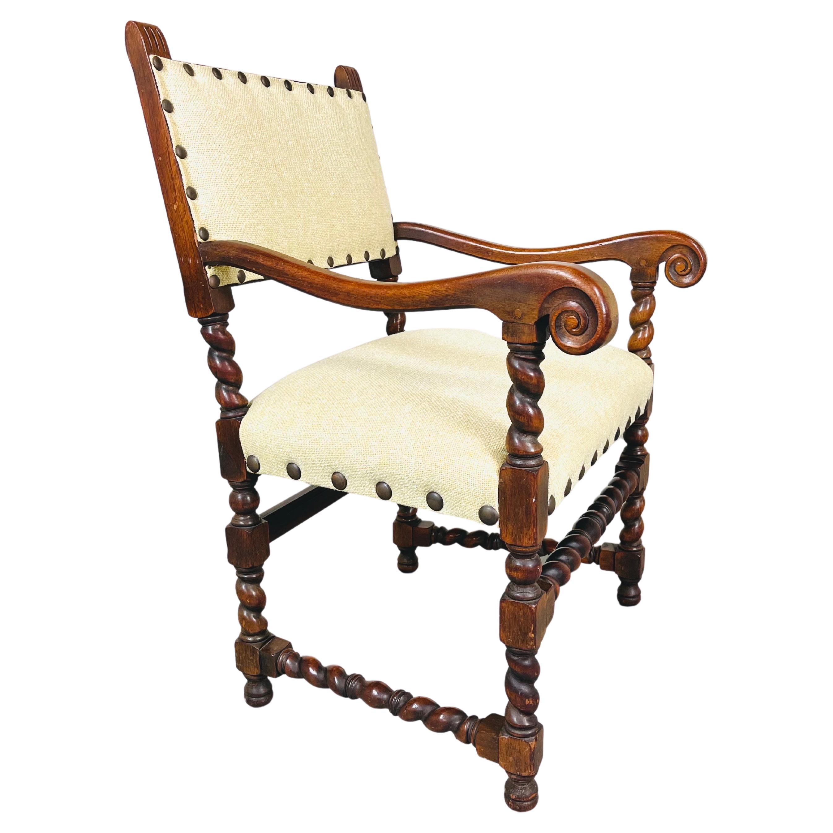 A beautiful and solid turned walnut Jacobean Barley Twist Armchair by Kittinger Furniture Compan, circa 1890 having fresh tweed cotton/poly blend upholstery with bordering chunky brass buttons throughout. Beautiful accents including hand carved