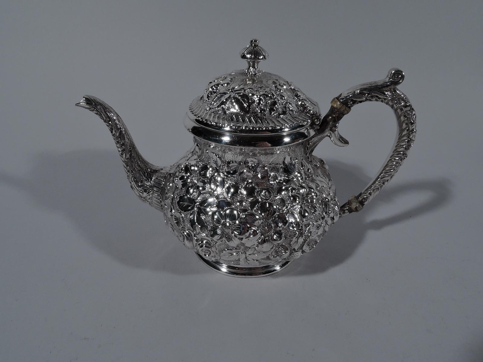 Turn of the century 3-piece sterling silver bachelor tea set. Made by Jacobi & Jenkins in Baltimore. This set comprises teapot, creamer, and sugar. Teapot bellied with hinged and domed cover, s-scroll spout, and plain stepped foot. Creamer gently