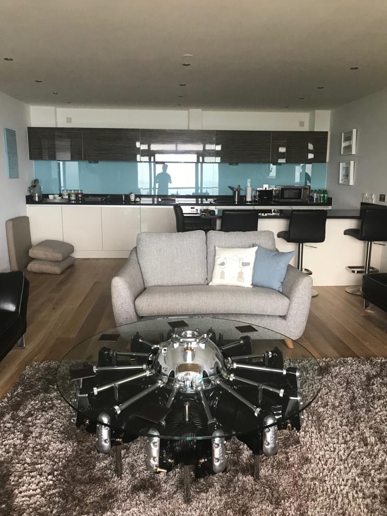 A highly polished glass top coffee table created from a Jacobs R-755-9 aircraft radial engine. The glass top is precision cut toughened glass.

A work of art in itself. Truly stunning.

 