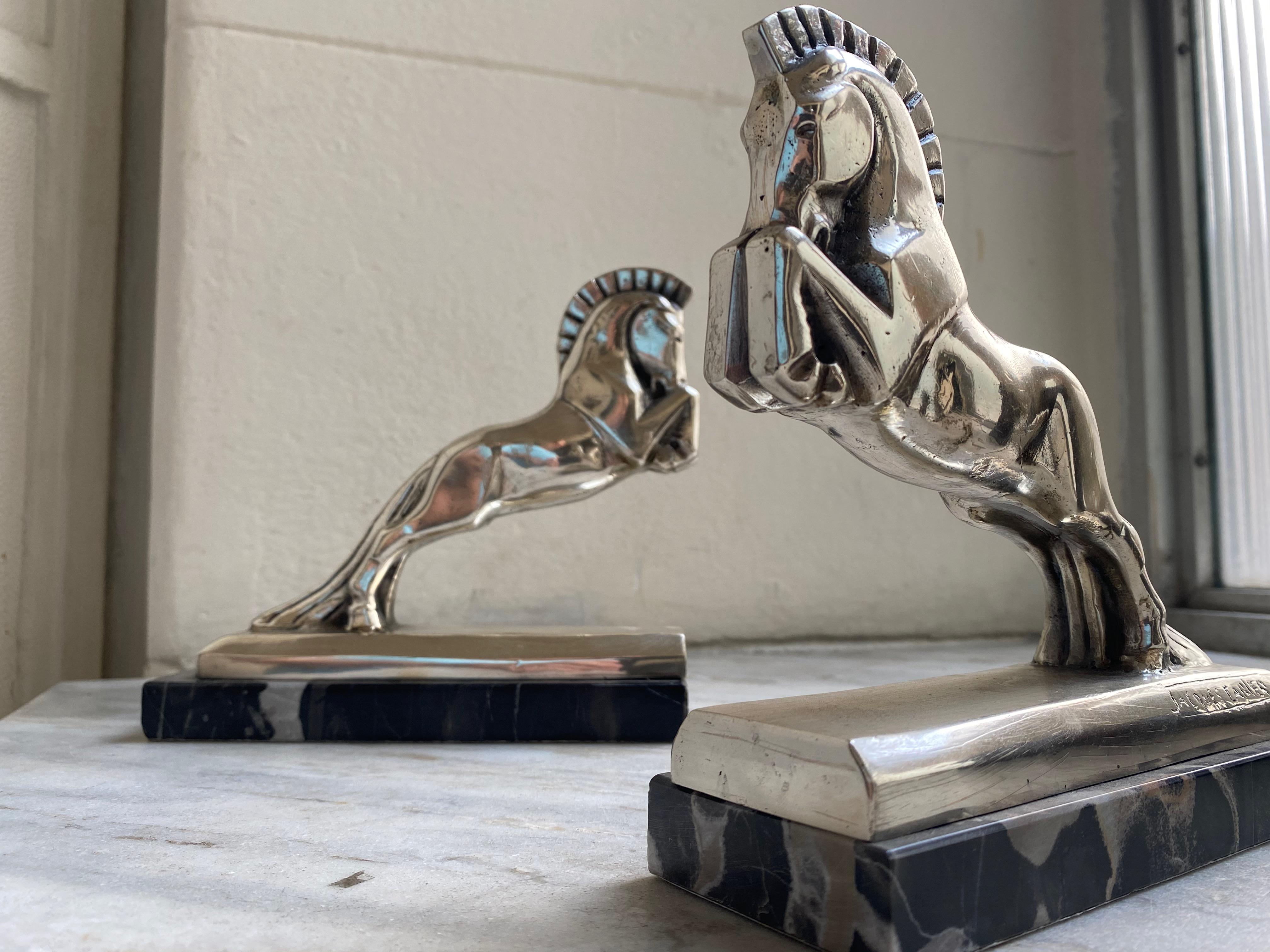 Silvered plated bronze Art Deco horse bookends by Jacques Cartier (French, 1907-2001). Both signed Jacques Cartier in lower area and both on a black marble base. Made in France, circa 1930. Cubist sculpture of an equestrian horse with bold mane.