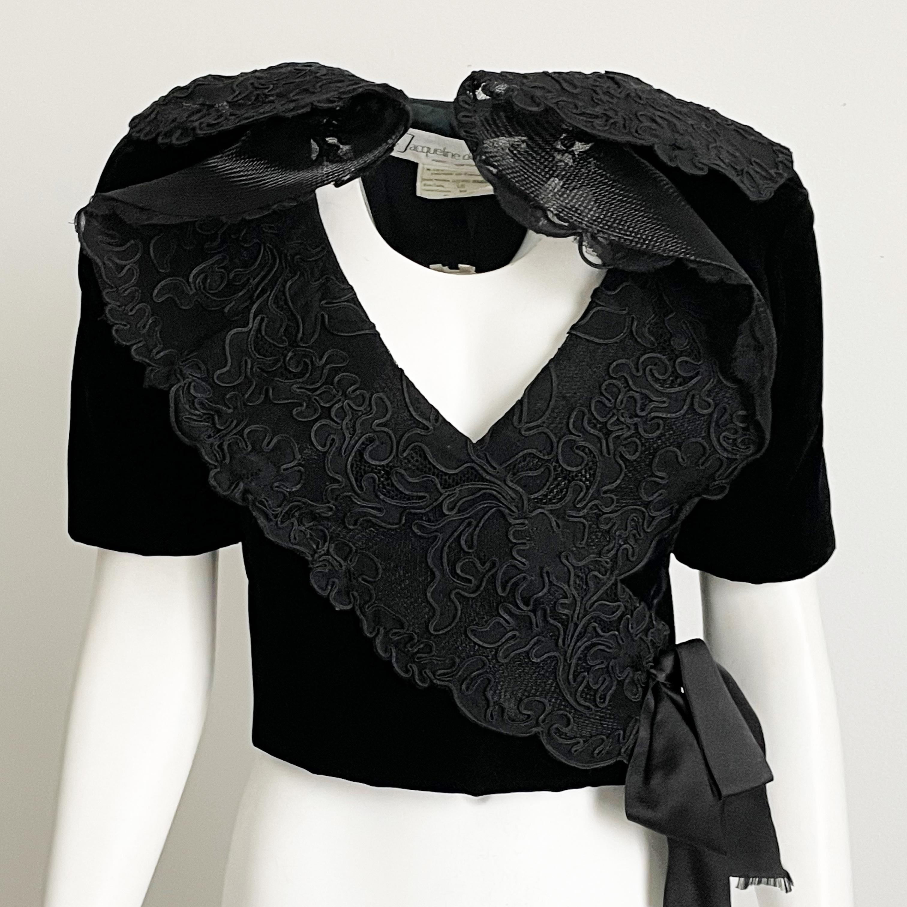 Preowned, vintage Jacqueline de Ribes black velvet bolero jacket with lace trim, circa the 80s.  

Made from black velvet, it features an oversized lace collar with tulle backing for shape.  It fastens with a hidden snap closure. 

Pair with your