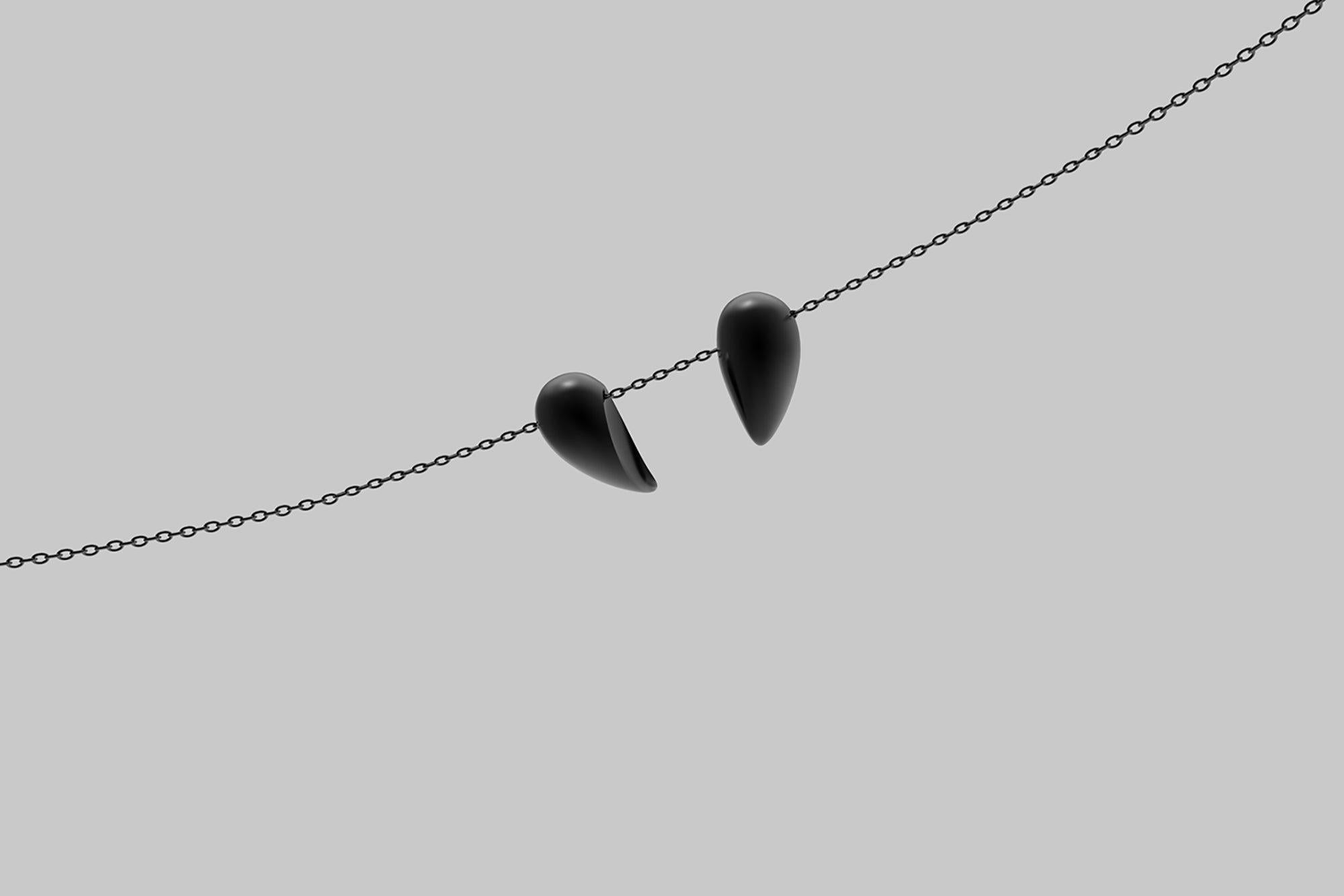 Jacqueline Rabun 
'Black Love' Large Pendant
Oxidised Sterling Silver

Two seeds symbolising transformation and change come together to delicately form a sculptural heart symbol, a talisman illustrating the beauty, elegance and grace of the heart of