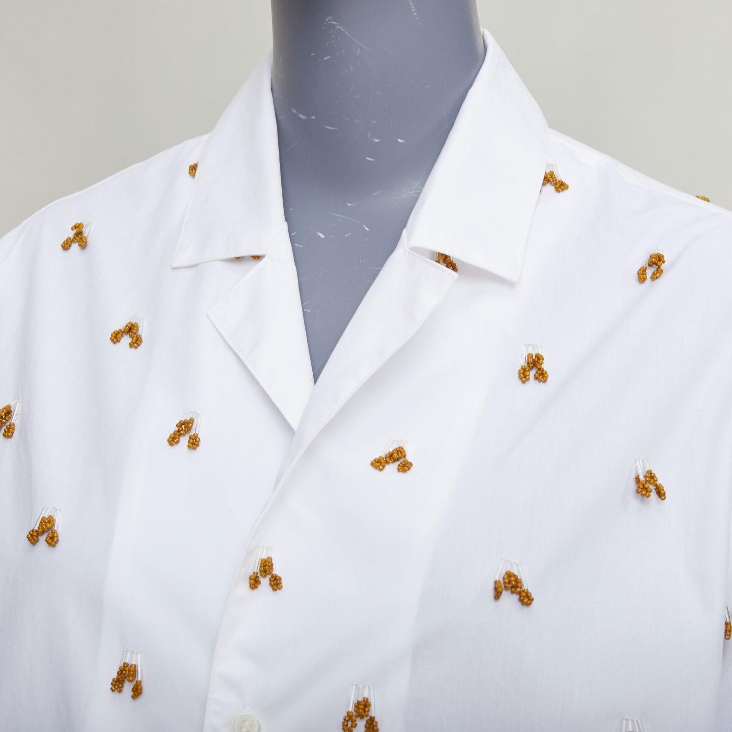 JACQUEMUS 2021 L'amour La Chemise Ble camisa blanca de algodón con adornos de cristal FR34 XS
Referencia: NKLL/A00514
Marca: Jacquemus
Model No: La Chemise Bl√©
Colección: L'amour SS 2021
Material: Algodón, Vidrio
Color: Blanco, Marrón
Patrón: