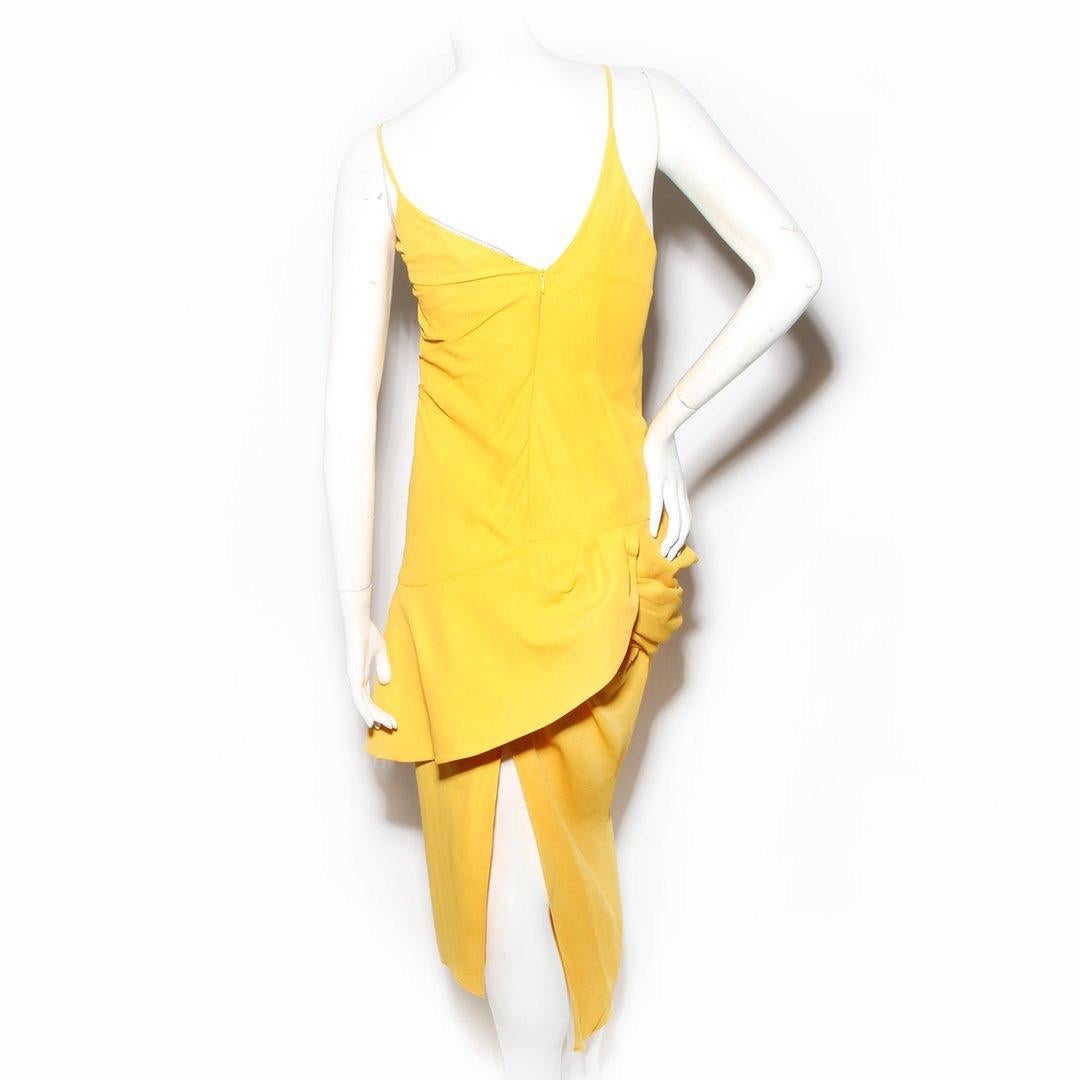 Jacquemus Dress
Spring / Summer 2018 Ready-to-Wear 
Look 32
Yellow 
Fitted style dress
Thin straps 
V-Neckline 
Peplum detail on left side of dress
Ruched detailing on left of dress
Invisible zipper down back of dress
Asymmetrical hem of skirt