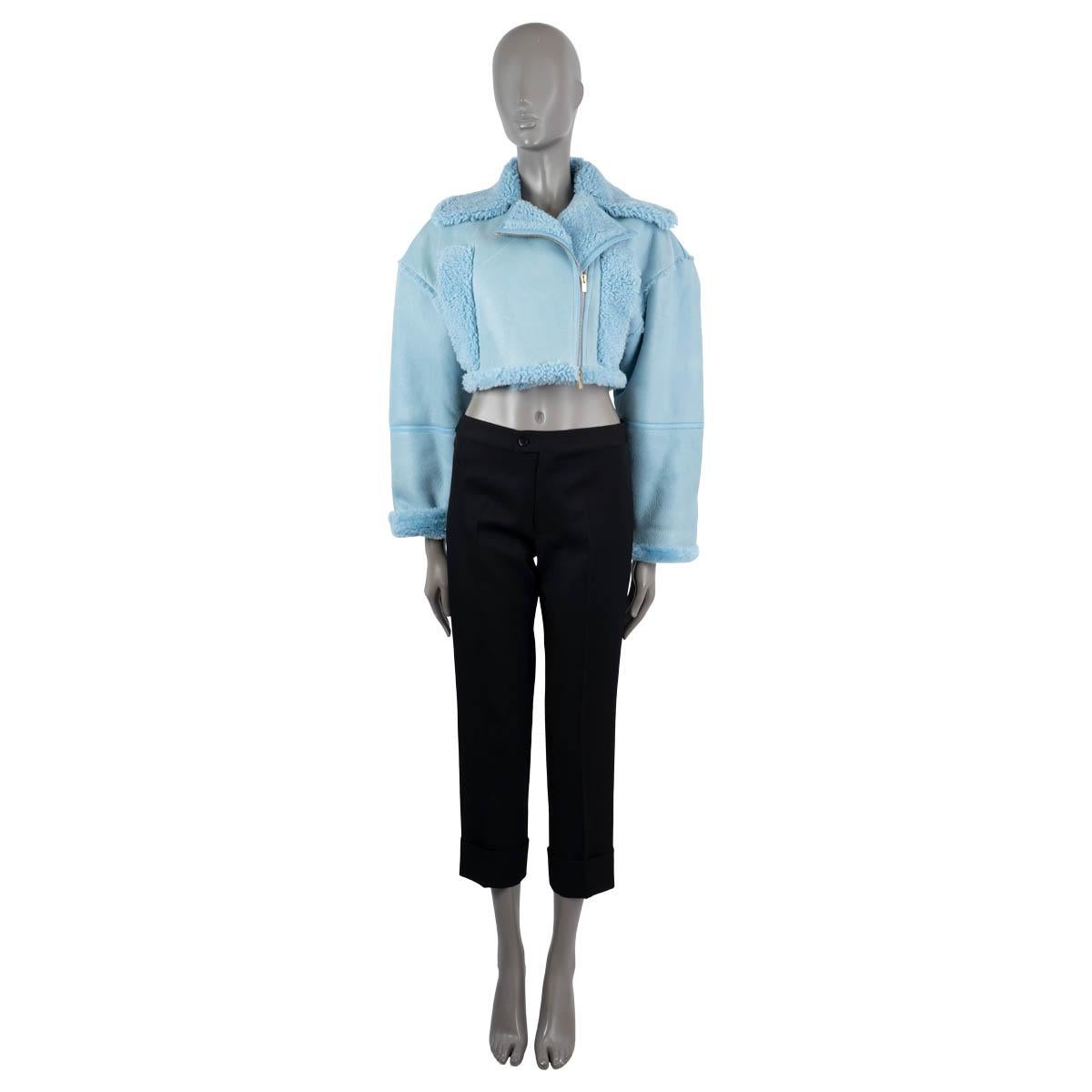100% authentic Jacquemus Paiou biker jacket in light blue leather and shearling. Features side pockets in shearling and a cropped silhouette. Opens with asymmetric zipper on the front. Lined in shearling. Has never been worn but shows some slight