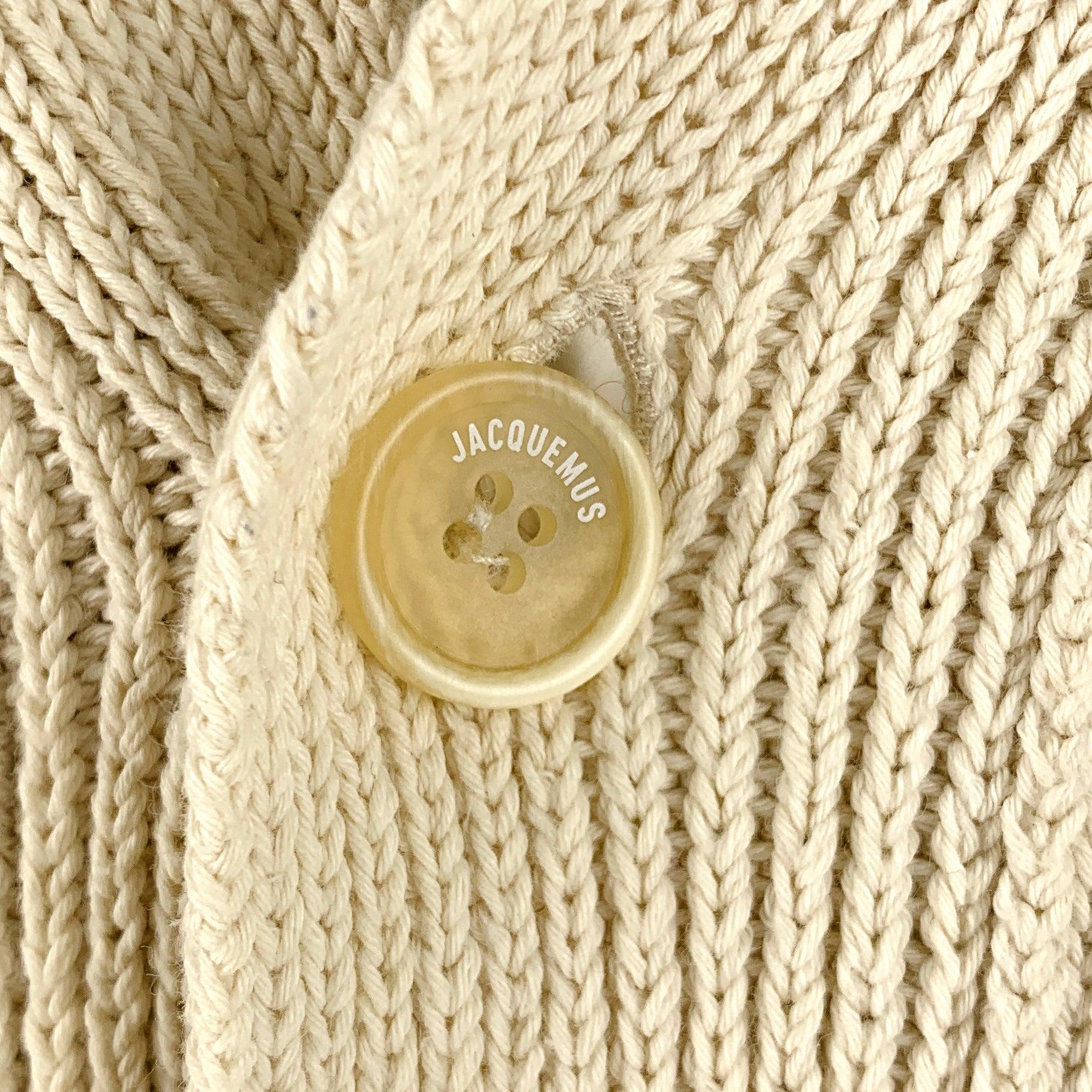 JACQUEMUS cardigan
in a cream cotton blend knit featuring an oversized style, rib knit technique, yellow trim, and button closure. Made in Italy.Very Good Pre-Owned Condition. Minor marks. 

Marked:   XL 

Measurements: 
 
Shoulder: 20 inches Chest: