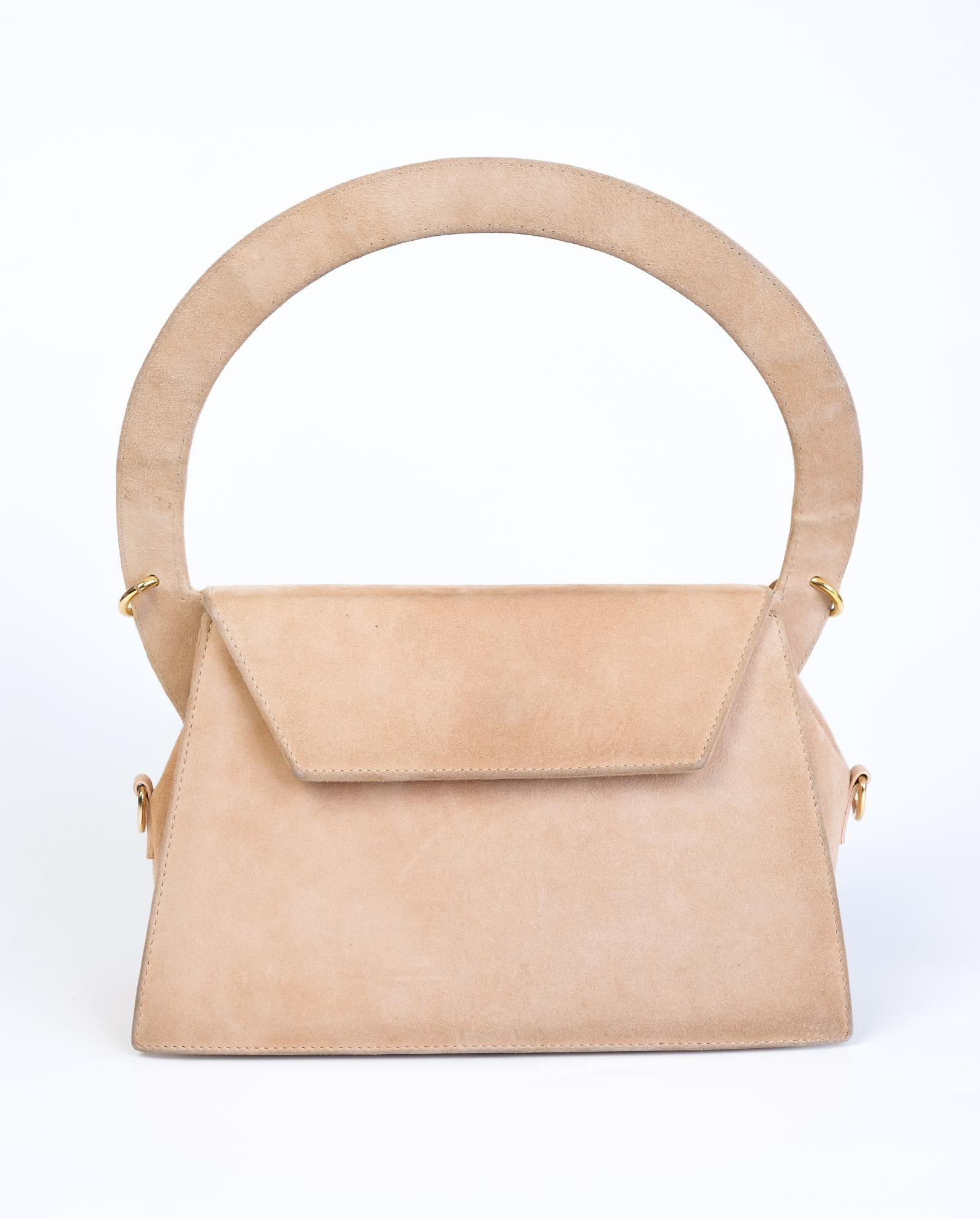 Handcrafted with suede leather, this style has a top handle, a chain link embellishment, a fold over flap closure and designer logo plaque on the front.

COLOR: Nude
MATERIAL: Suede
MEASURES: H 13” x L  11” x D 4.1”
EST. RETAIL: $1000
COMES WITH: