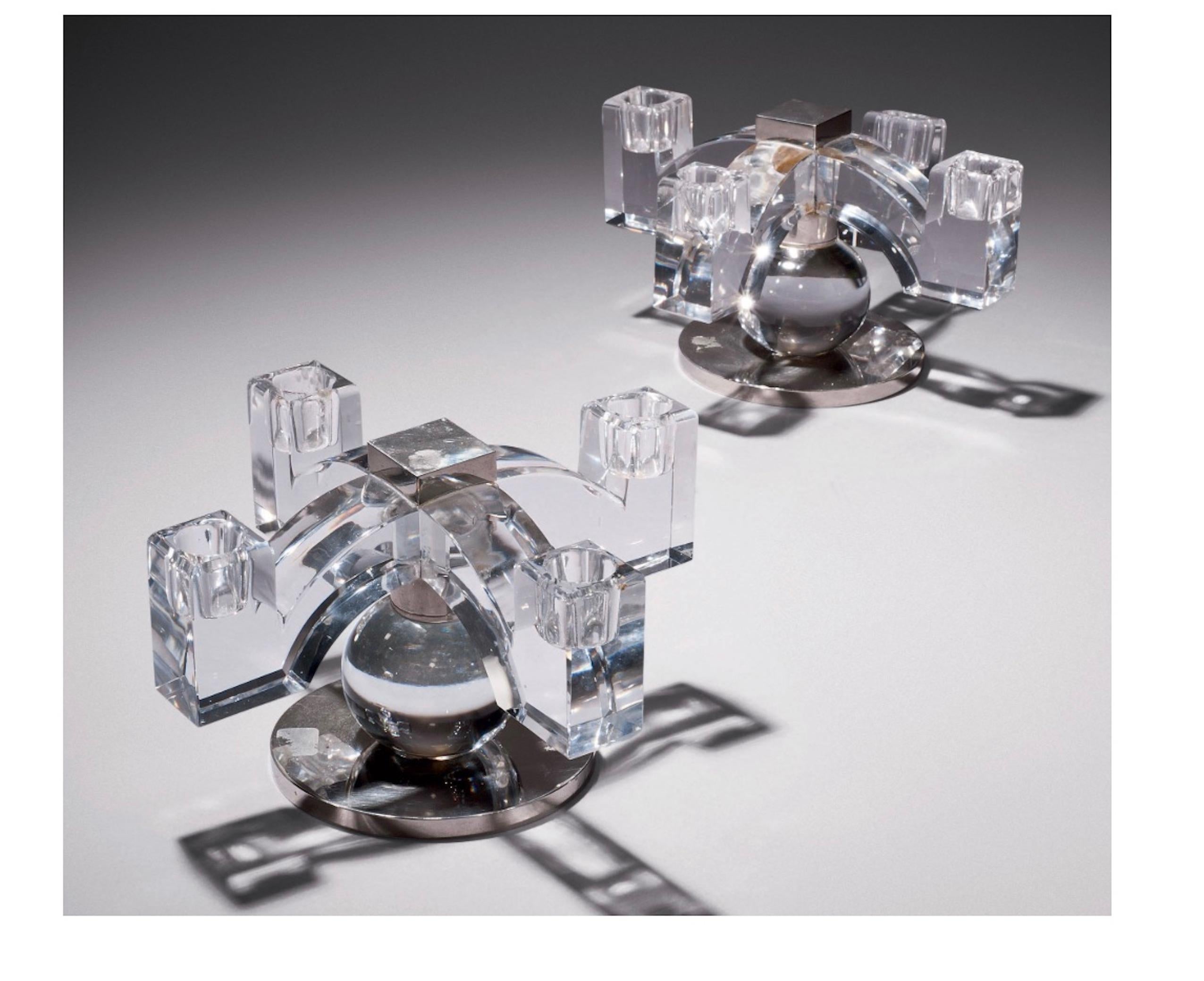 Vers 1930. H: 14.5 cm A pair of four branch modernistic candle holders in translucent crystal standing on a sphere and circular nickel-plated base. Acid-etched stamp of Maison Baccarat, circa 1930. H: 5 ¾ in.
