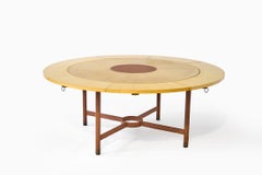 Jacques Adnet (1900-1984), Dining table with a circular sycamore veneer top.