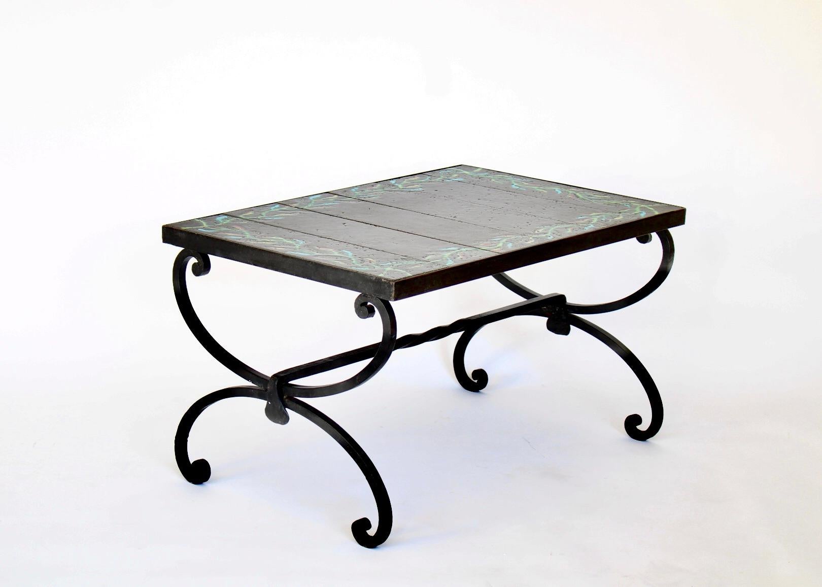 Jacques Adnet and Guidette Carbonell coffee table or side table. Use as a side table or the perfect small coffee table. Hand wrought iron base with six inset glazed ceramic tiles with a twining vine motif in shades of green, blue and touches of rust