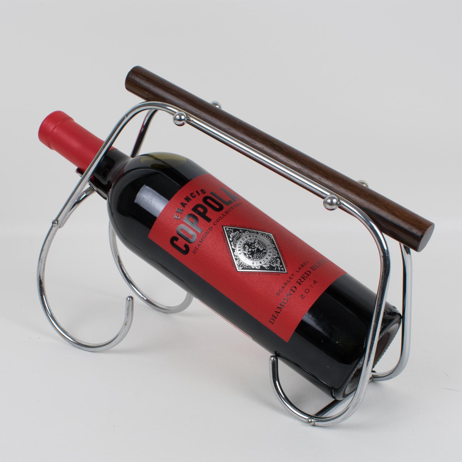 This stunning French Art Deco bottle holder was designed by Jacques Adnet (1901 - 1984). The rare barware piece was crafted in France circa 1940. This wine pourer or server is made of chrome metal, features a streamlined design, and boasts a large